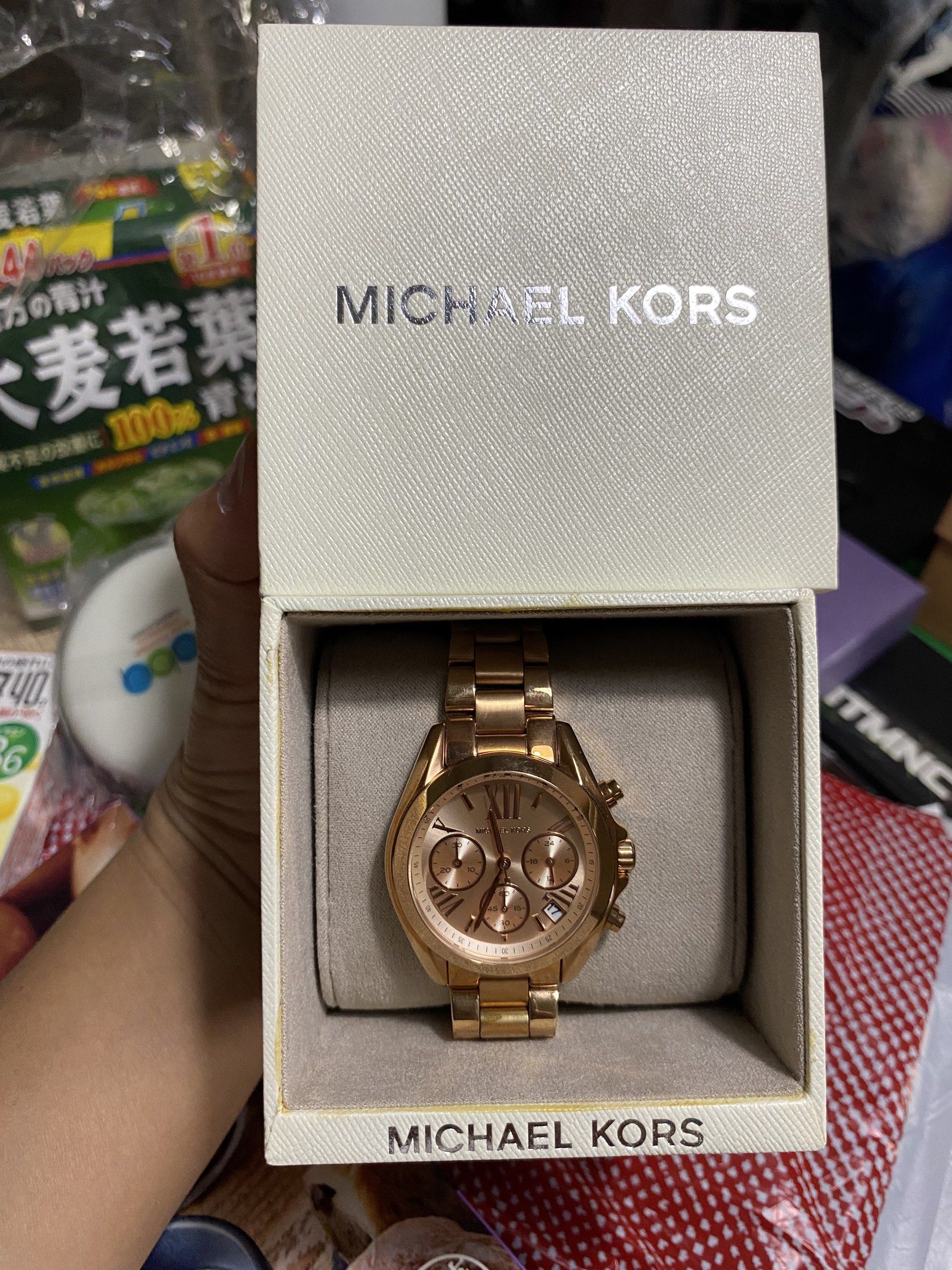Michael Kors Rose Gold Chronograph Watch (Category: Luxury Watches) located in Pasig City. Submitted by elise.ensembles28 (Listing ID 1419799673, Image 2). Description: Michael Kors Bradshaw Rose Gold Stainless Steel Watch (MK5799), featuring a rose gold-toned dial and a 37mm case. Brand/Model: Michael Kors MK5799 Bradshaw. Material: Rose gold-plated stainless steel. Features: Chronograph functionality with a date display at 3 o’clock. Case Size: