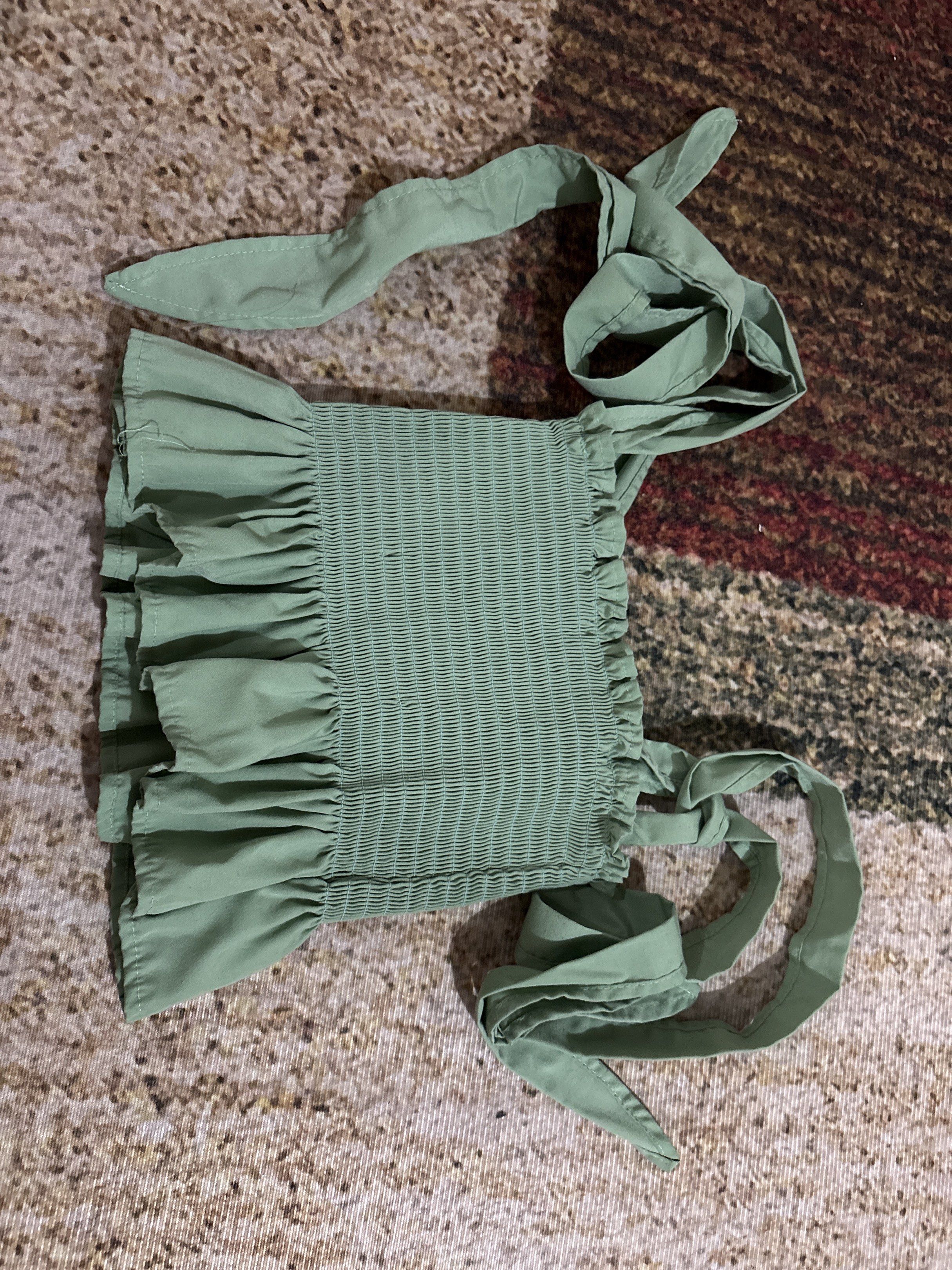 NAKD Fashion Liam Smocking Self Tie Top (Category: Sleeveless) located in Makati City. Submitted by asphh (Listing ID 1419906784, Image 1). Description: - Smocked bodice - Self-tie straps - Ruffled hem - Light green color - Perfect for summer - Casual wear - Stylish and versatile.