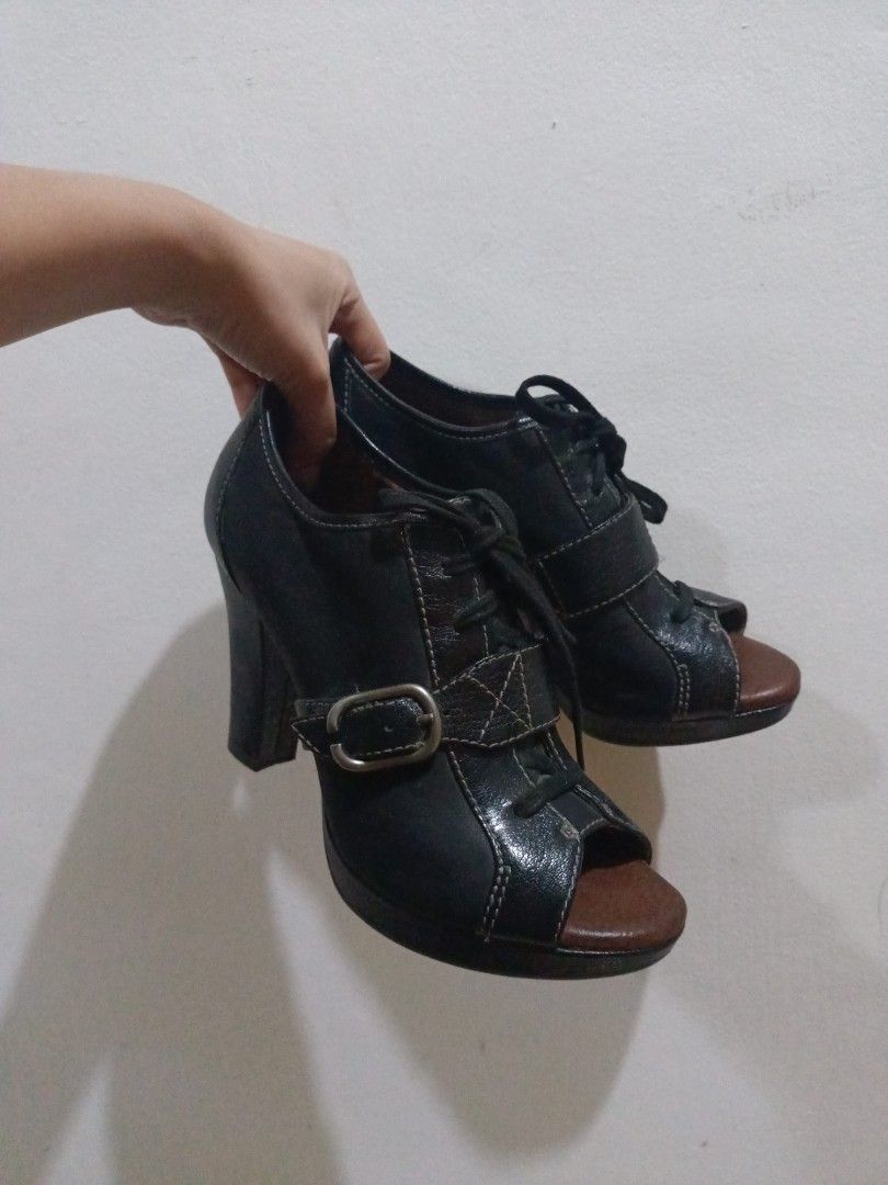 Naya Black Heels (Category: Heels) located in Bislig. Submitted by vanityarchives (Listing ID 1419919388, Image 1). Description: - Black peep toe heels - Buckle and lace-up design - Sturdy block heel - Brown soles - Comfortable and chic - Versatile for any outfit - U.S. Brand.