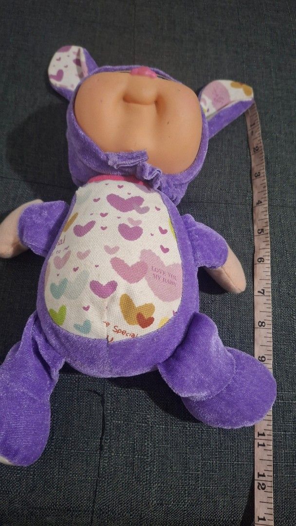 Original Cabbage patch Purple Baby Doll (Category: Plushies & Soft Toys) located in Quezon City. Submitted by _helpmedeclutter (Listing ID 1419899524, Image 3). Description: - Adorable plush baby doll - Dressed in a purple outfit - Soft body with patterned back - Sleeping face with closed eyes and pink nose - Purple arms and legs.