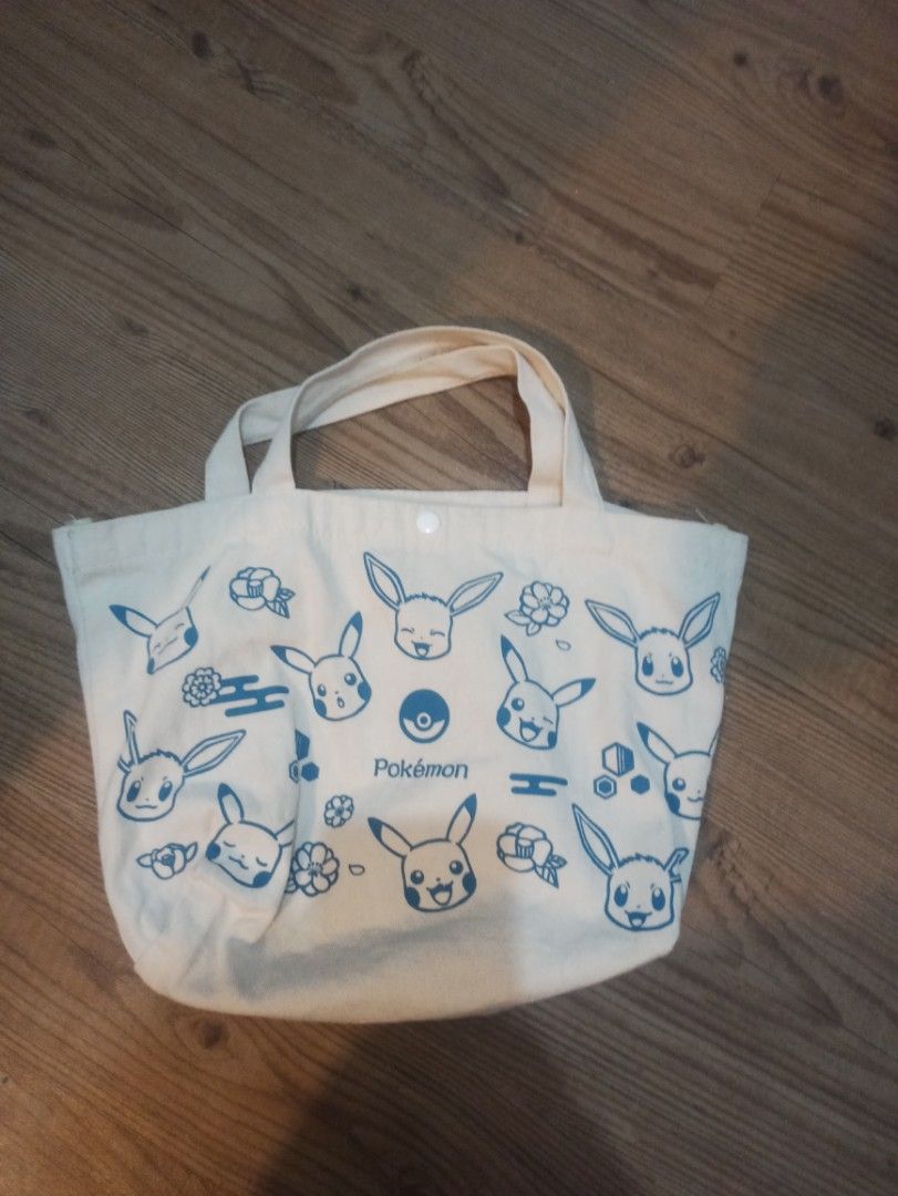 Pokemon Tote Bag (Category: Tote Bags) located in Manila. Submitted by avrilarqu43176 (Listing ID 1419970249, Image 1). Description: - Pokemon themed tote bag - Button closure - Sturdy handles - Light-colored fabric - Blue Pokemon graphics - Perfect for everyday essentials - Great for Pokemon fans.