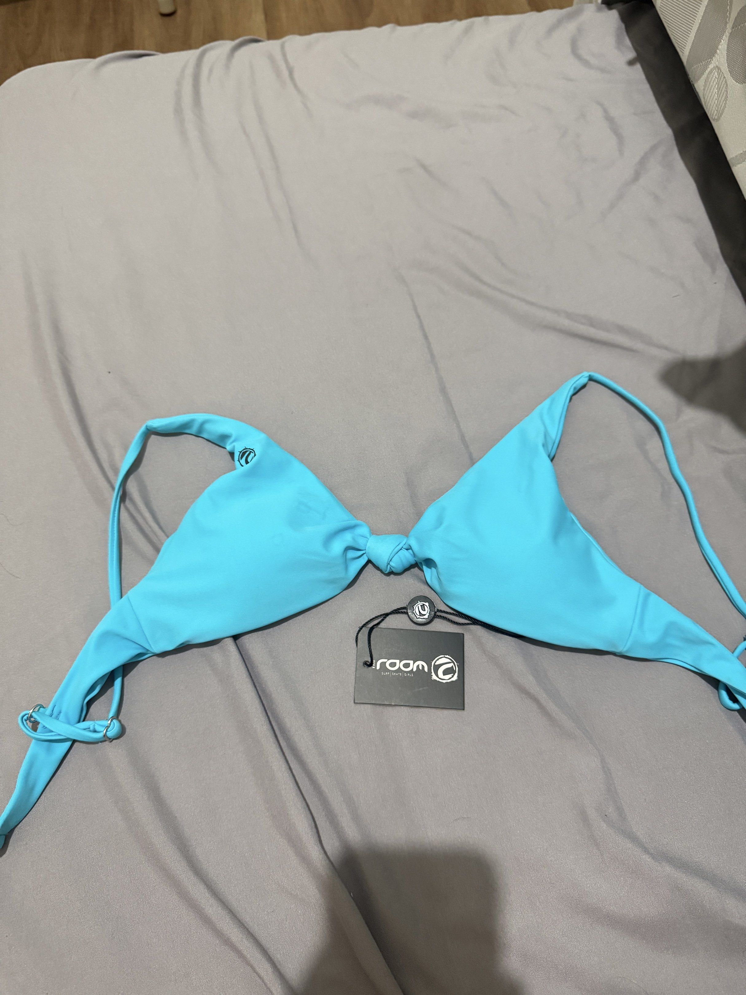 Rooom Bikini Top - Size S - Turquoise (Category: Bikinis & Swimsuits) located in Pasig City. Submitted by caaex (Listing ID 1419939123, Image 1). Description: - Rooom turquoise bikini top - Size: S - Design: Knotted center - Features: Adjustable straps - Condition: New with tags.