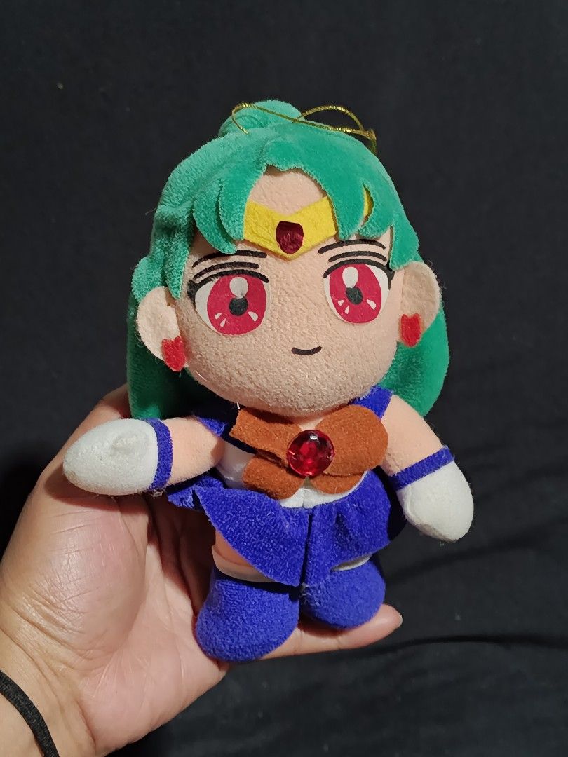 Sailor Moon Sailor Uranus Plush Toy (Category: Plushies & Soft Toys) located in Compostela. Submitted by buenaflora04681 (Listing ID 1419857308, Image 1). Description: Sailor Uranus plush toy. It features green hair, a blue and orange outfit, and red eyes. The plush has a gold string for hanging. It is a cute and collectible item for any Sailor Moon fan..