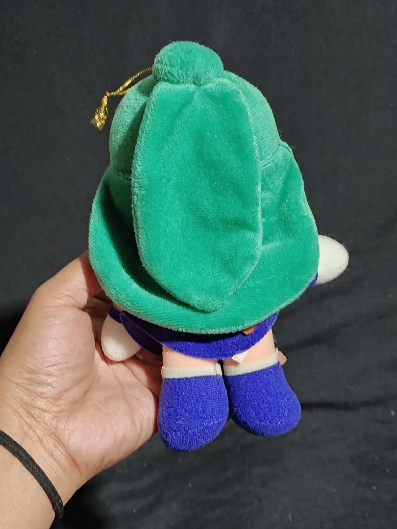 Sailor Moon Sailor Uranus Plush Toy (Category: Plushies & Soft Toys) located in Compostela. Submitted by buenaflora04681 (Listing ID 1419857308, Image 2). Description: Sailor Uranus plush toy. It features green hair, a blue and orange outfit, and red eyes. The plush has a gold string for hanging. It is a cute and collectible item for any Sailor Moon fan..