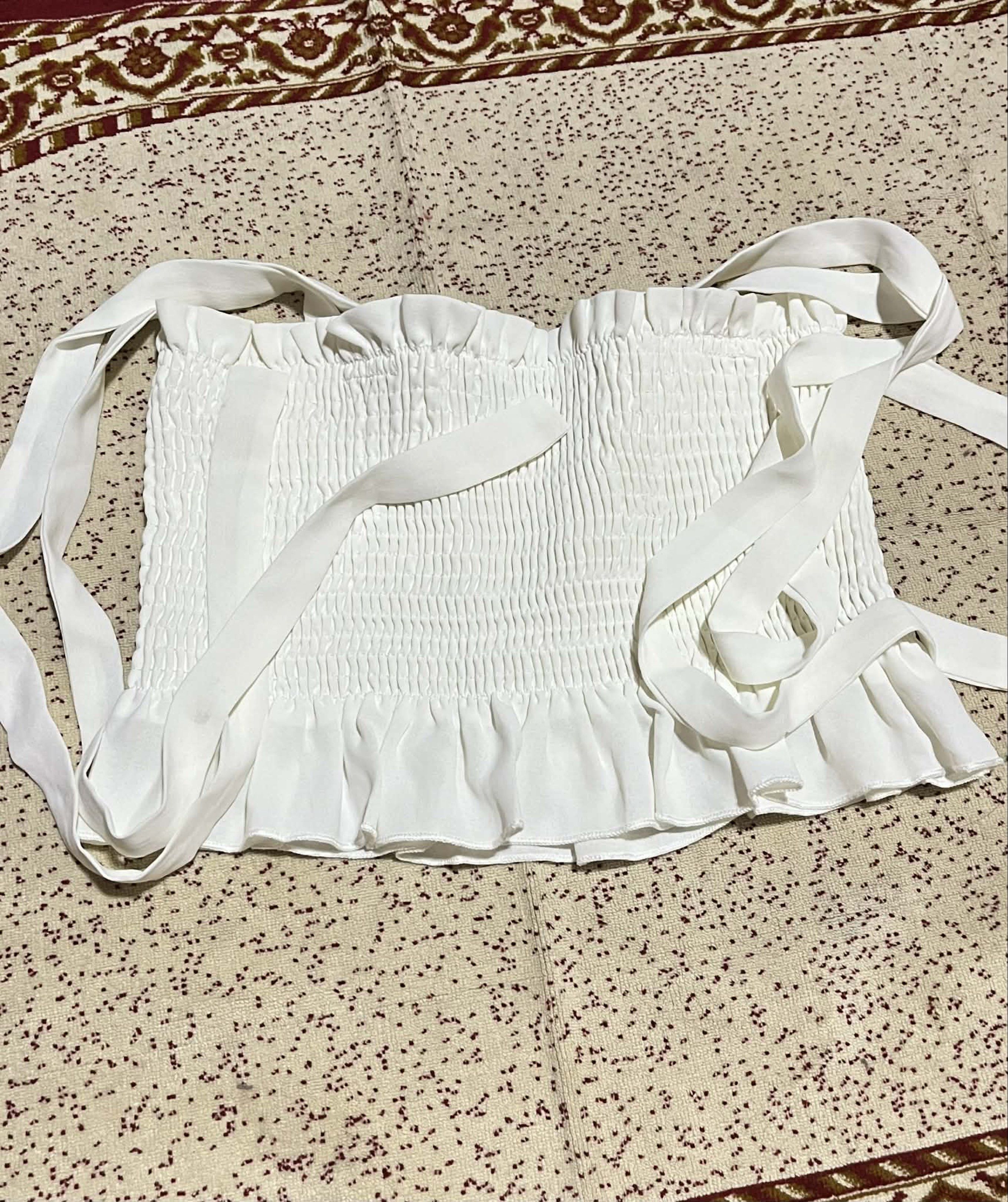 SHEIN White Smocked Crop Top (Category: Sleeveless) located in Bacolod City. Submitted by james_andrei (Listing ID 1419960699, Image 2). Description: Price 150 - SHEIN white crop top - Features a smocked bodice - Adjustable tie straps - Ruffled hem detail - Size: L (EU 40/42, US 8/10) Condition: Used twice only Flaws: N/A RFS: Decluttering Mode of Payment: GCash, Bank transfer Mode of Shipping: Jnt Express (SF shouldered by buyer).