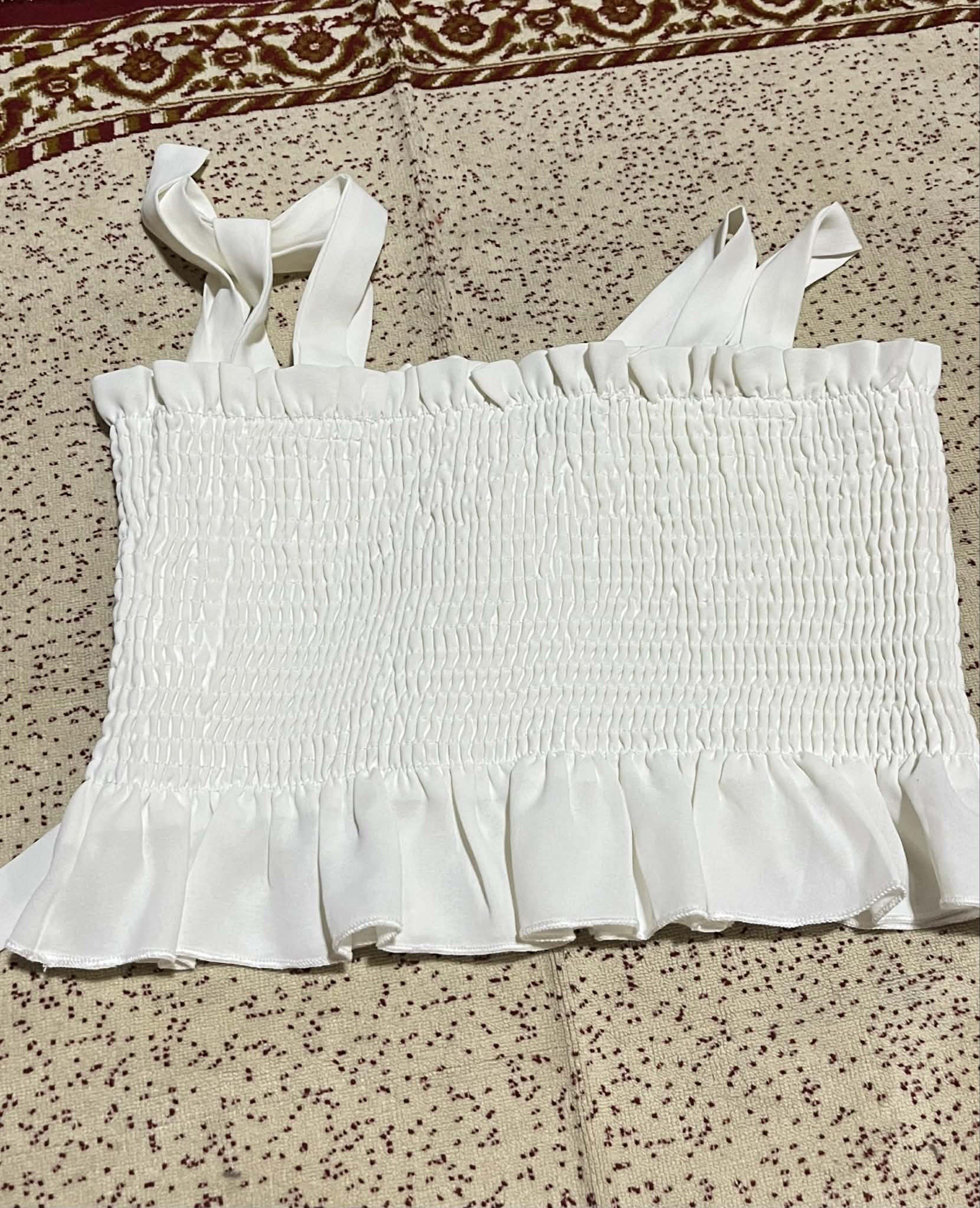 SHEIN White Smocked Crop Top (Category: Sleeveless) located in Bacolod City. Submitted by james_andrei (Listing ID 1419960699, Image 3). Description: Price 150 - SHEIN white crop top - Features a smocked bodice - Adjustable tie straps - Ruffled hem detail - Size: L (EU 40/42, US 8/10) Condition: Used twice only Flaws: N/A RFS: Decluttering Mode of Payment: GCash, Bank transfer Mode of Shipping: Jnt Express (SF shouldered by buyer).