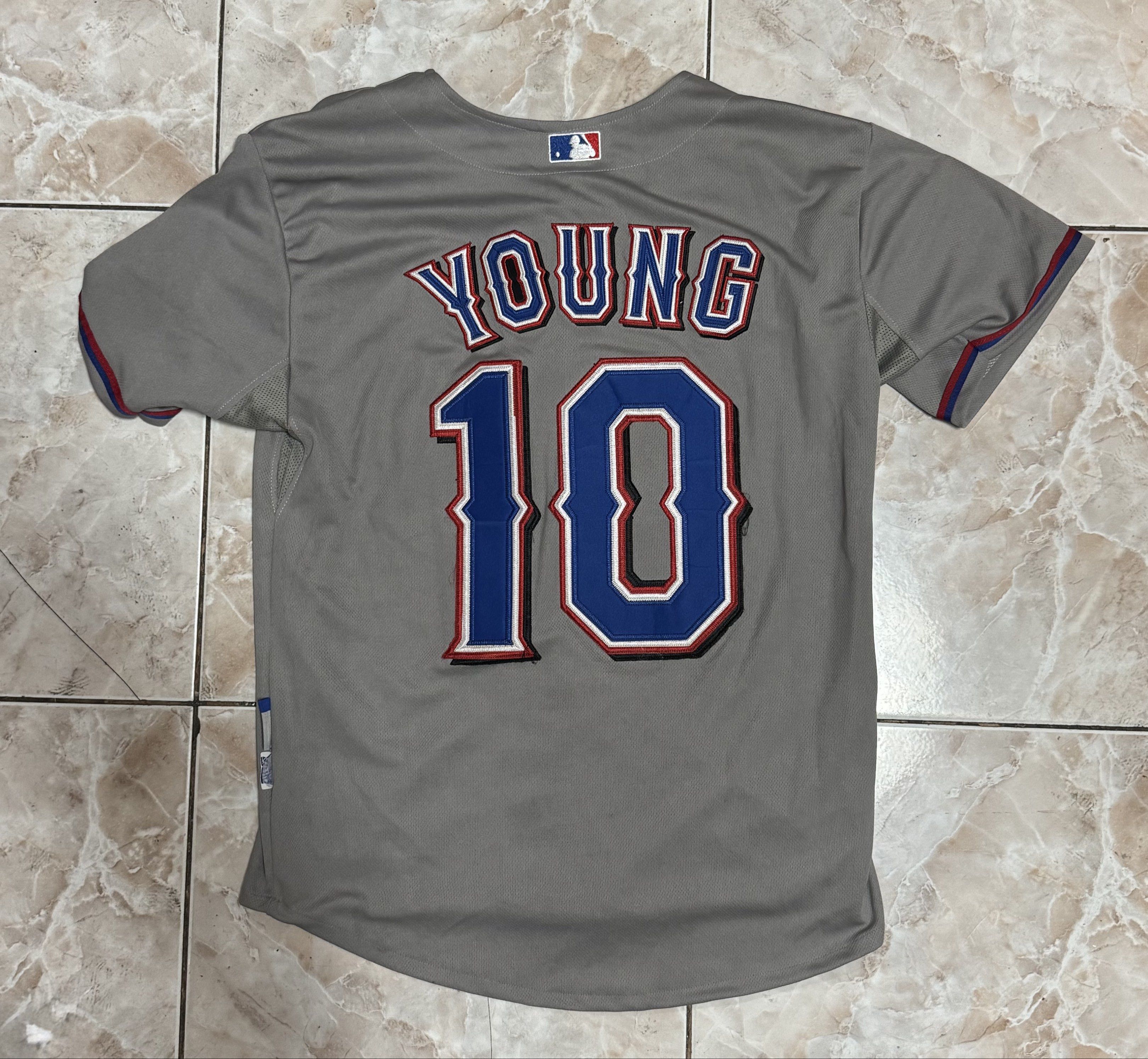 Texas Rangers Young #10 Baseball Jersey (Category: Activewear) located in Manila. Submitted by _dzmmm (Listing ID 1419782460, Image 2). Description: - Texas Rangers baseball jersey - Features "TEXAS" across the chest - "YOUNG 10" on the back - Includes World Series patch - Made by Majestic - Button-up front - Short sleeves Pm for more infos - Guaranteed Authentic - Condition 9/10 - Color rate 9/10 - No issues - Vintage.