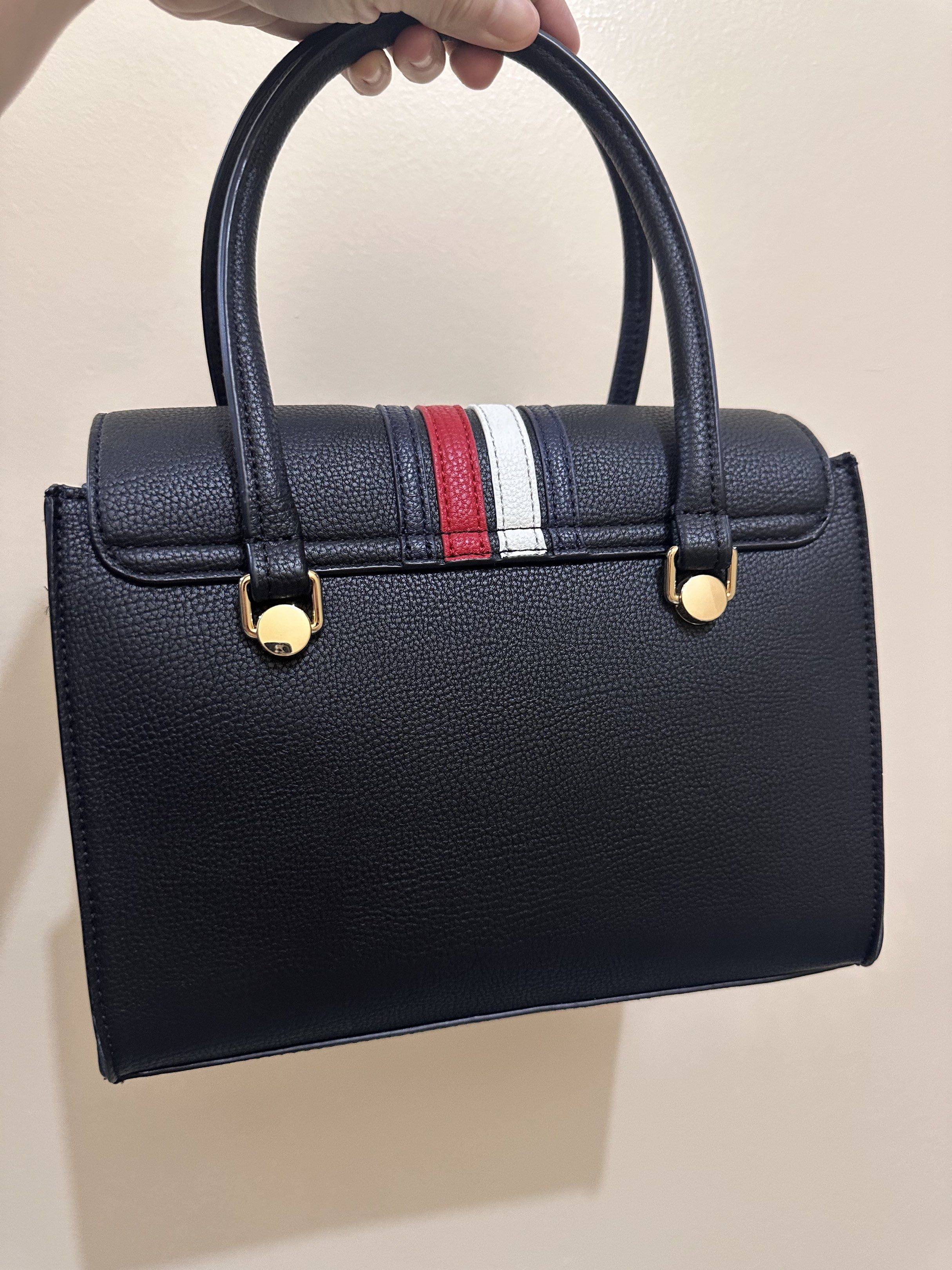 Tommy Hilfiger black Handbag shoulder bag (Category: Luxury Bags & Wallets) located in Binan City. Submitted by pcdads (Listing ID 1419871371, Image 2). Description: Given as gift. Tag has been removed but was never used. - black handbag - Flap closure - Dual top handles - Detachable strap - Striped design (red, white, black) - Multiple interior compartments - Gold-toned hardware - Textured exterior.
