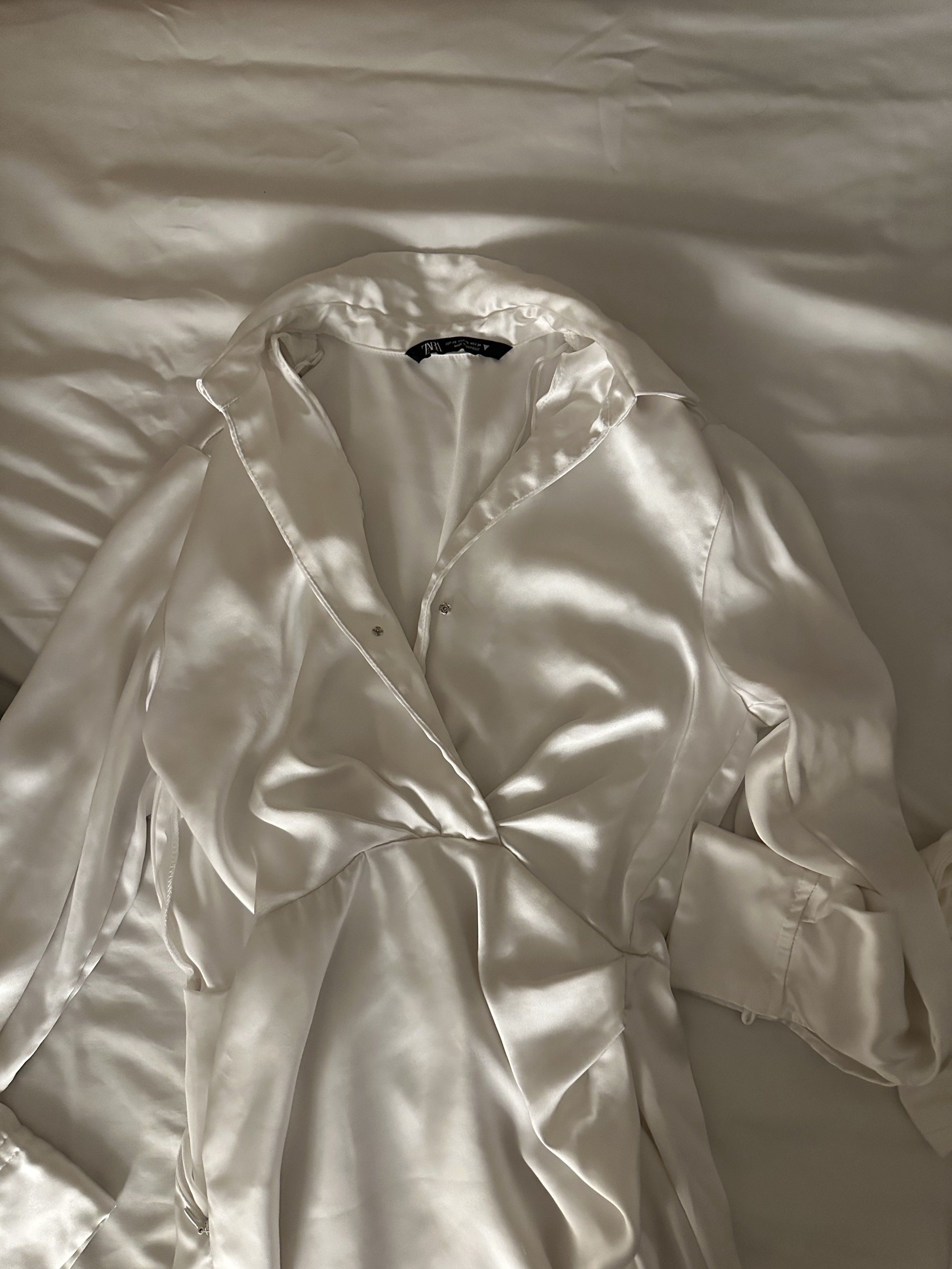 white satin wrap dress (Category: Dresses) located in Cainta. Submitted by brberry (Listing ID 1419887303, Image 2). Description: 🪭 zara white satin dress 🪭 handsewn a button for #safety as seen on 2nd pic, not stretchy 🪭 size: XS 🪭 rfs: not my style anymore 🪭 shipping: buyer books with any app + shoulders the fee / can meet up in UST.