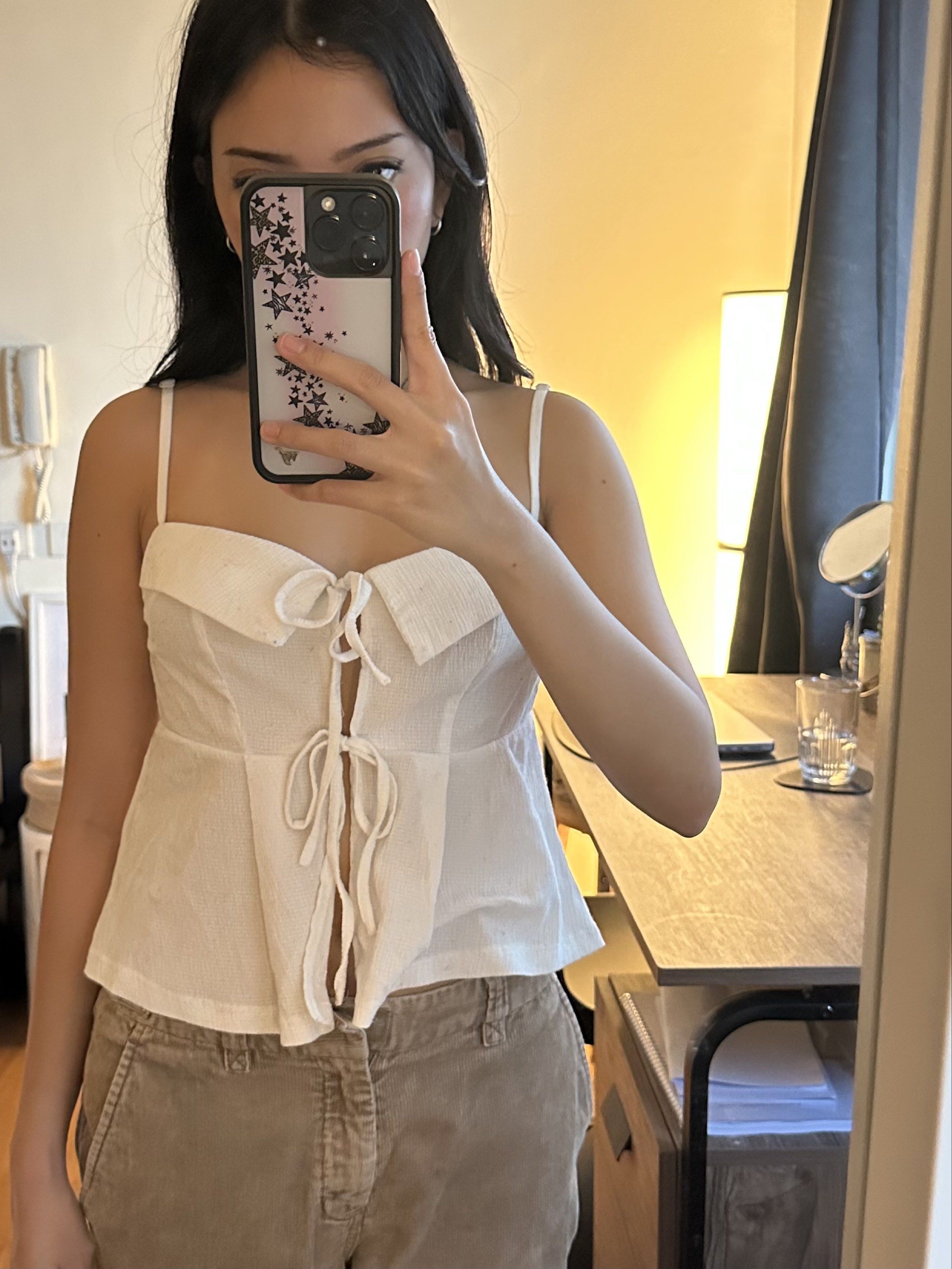 white tie-front top (Category: Sleeveless) located in Cainta. Submitted by brberry (Listing ID 1419877223, Image 1). Description: 🪭 white tie-front cami tank top 🪭 size: XS-S 🪭 rfs: not my style anymore 🪭 shipping: buyer books with any app + shoulders the fee / can meet up in UST.