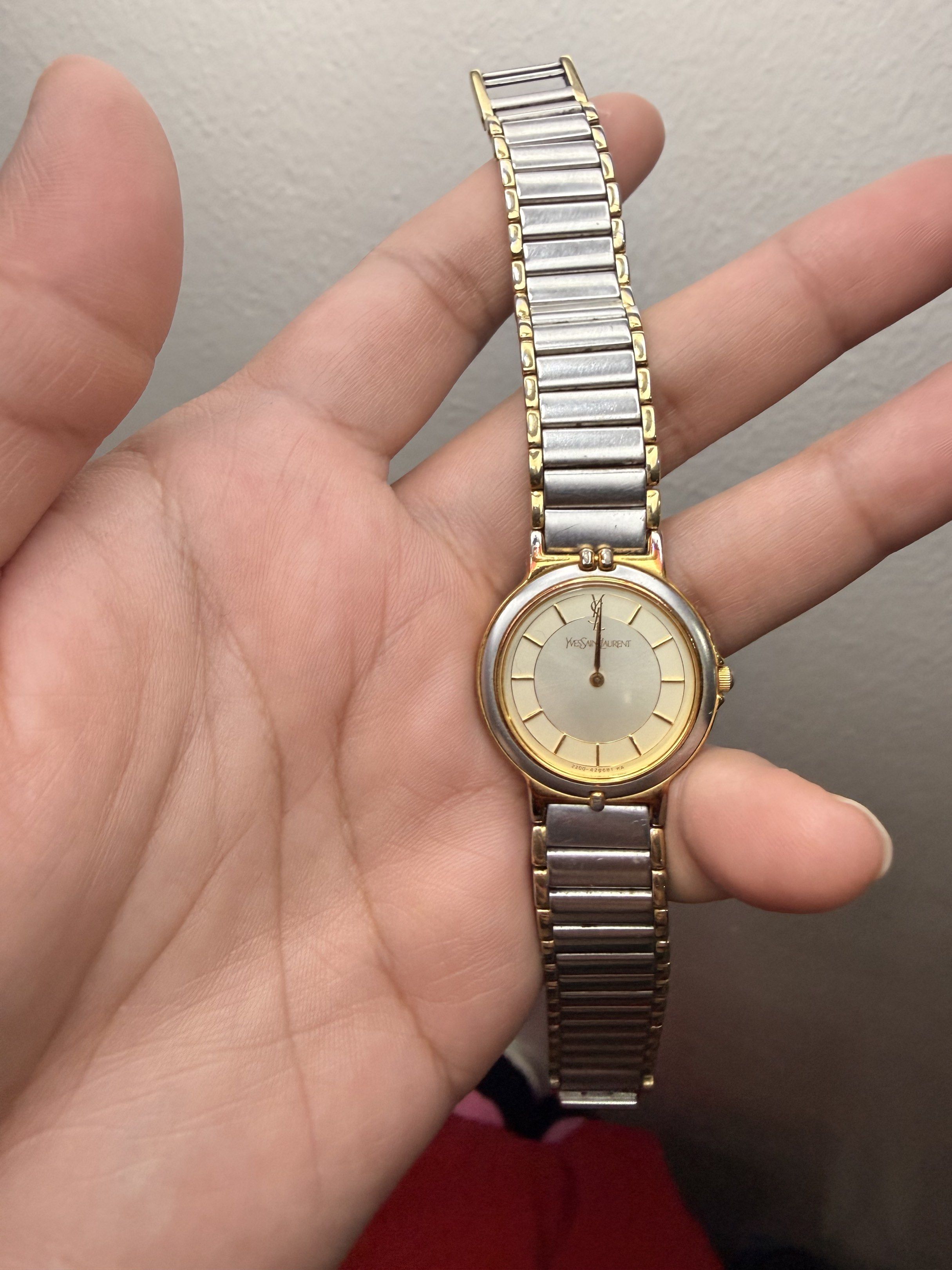 YSL Yves Saint Laurent Watch (Category: Luxury Watches) located in Quezon City. Submitted by maefurio (Listing ID 1419918670, Image 3). Description: - YSL watch with a gold and silver design. - Round face with a light-colored dial. - Features gold hands. - Band combines silver and gold links. - YSL logo and model info on the back. - Perfect for everyday wear. ✨100% authentic money back if proven fake✨ -no additional links , as is where is. - for 