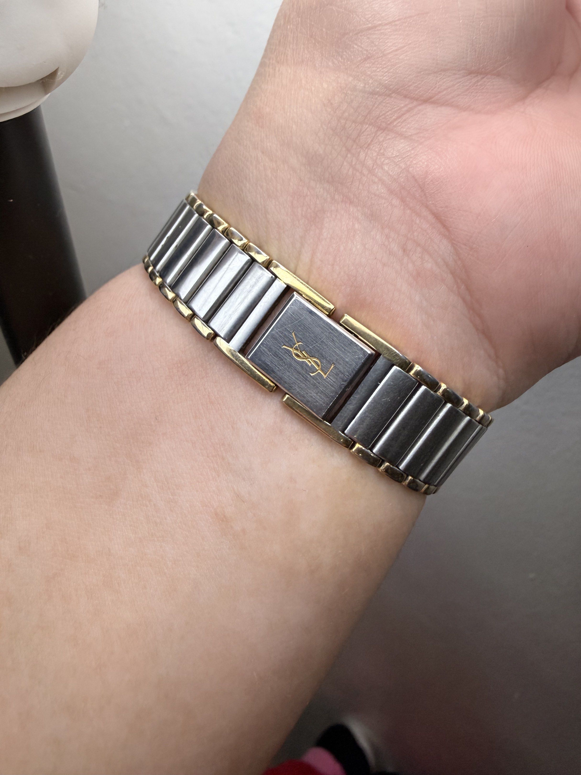 YSL Yves Saint Laurent Watch (Category: Luxury Watches) located in Quezon City. Submitted by maefurio (Listing ID 1419918670, Image 2). Description: - YSL watch with a gold and silver design. - Round face with a light-colored dial. - Features gold hands. - Band combines silver and gold links. - YSL logo and model info on the back. - Perfect for everyday wear. ✨100% authentic money back if proven fake✨ -no additional links , as is where is. - for 