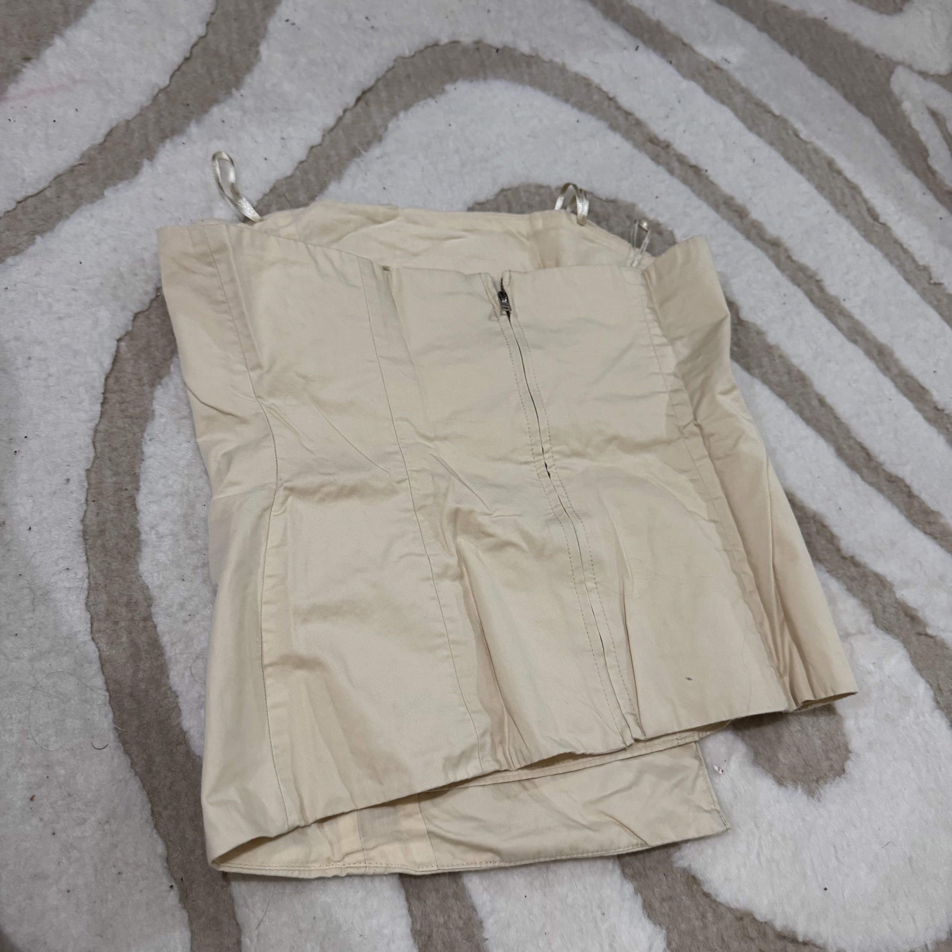 Zara Cream-colored Corset Top (Category: Sleeveless) located in Makati City. Submitted by finders.keep.hers (Listing ID 1419835835, Image 3). Description: - Cream-colored corset top - Features a front zipper - Structured silhouette - Made of smooth fabric - Thin straps - Tailored fit - Versatile style.