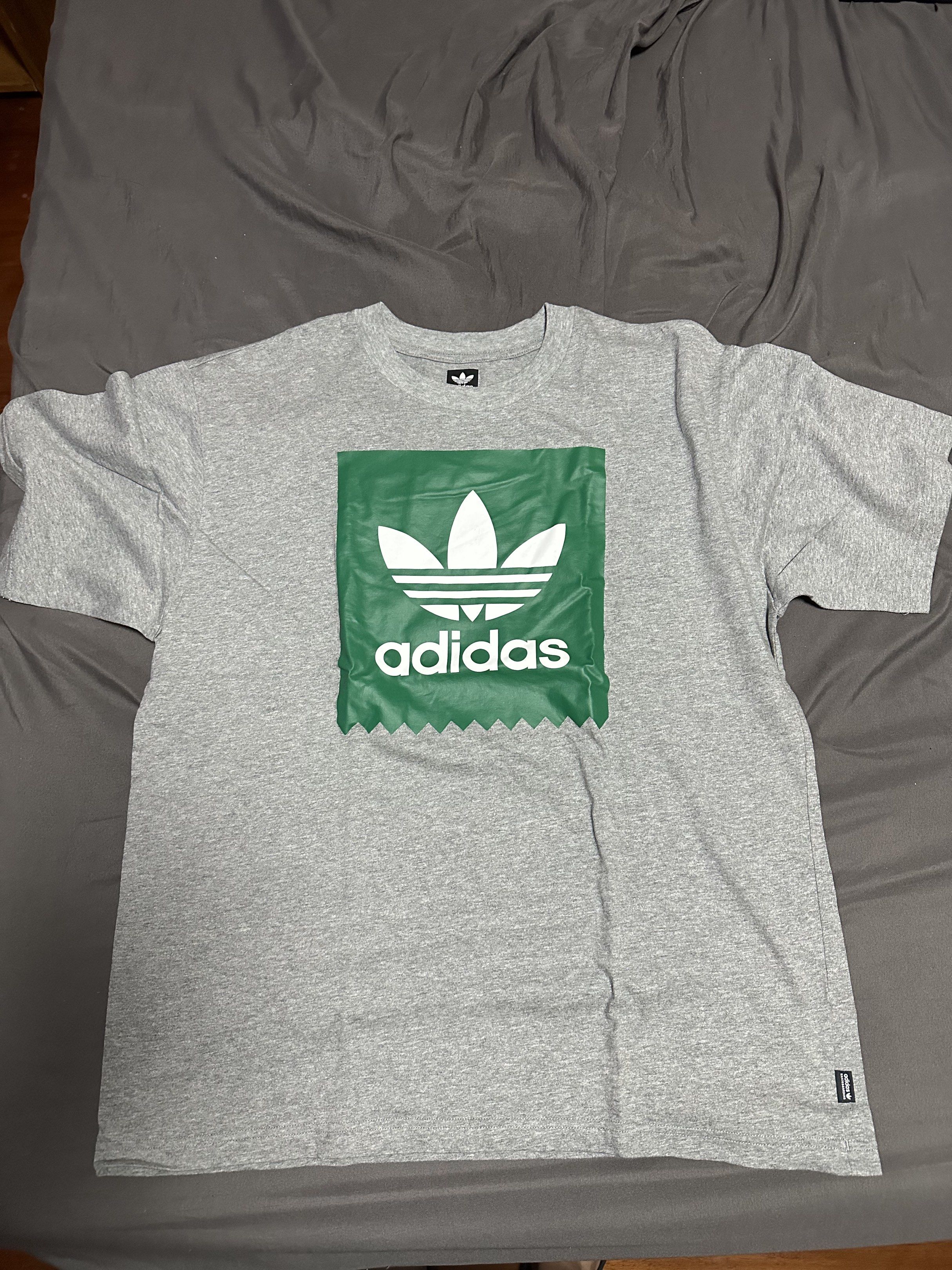 Adidas Graphic Tee (Category: Tshirts & Polo Shirts ) located in Paranaque City. Submitted by lancedleon (Listing ID 1420000458, Image 1). Description: Adidas Original Shirt, L on tag Adidas t-shirt with a green and white graphic. Features the Adidas logo. Soft material, crew neck, and short sleeves. Perfect for everyday wear..