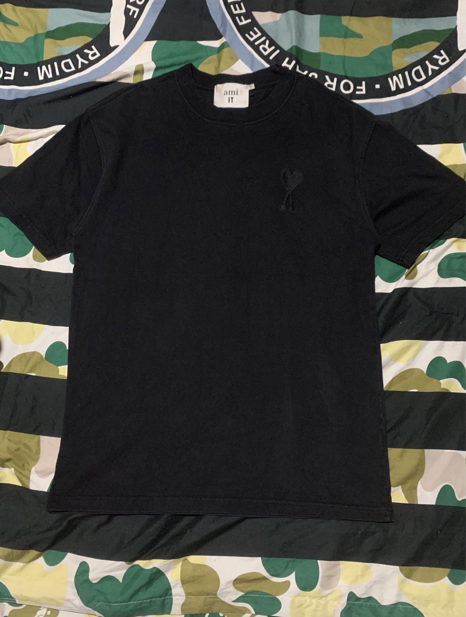 AMI Paris Black T-shirt XL (Category: Luxury Apparel) located in Cagayan de Oro. Submitted by agboysalis60090 (Listing ID 1420139585, Image 1). Description: Black AMI Paris T-shirt. Features the AMI de Coeur logo on the chest. The size is XL. The tag is visible..