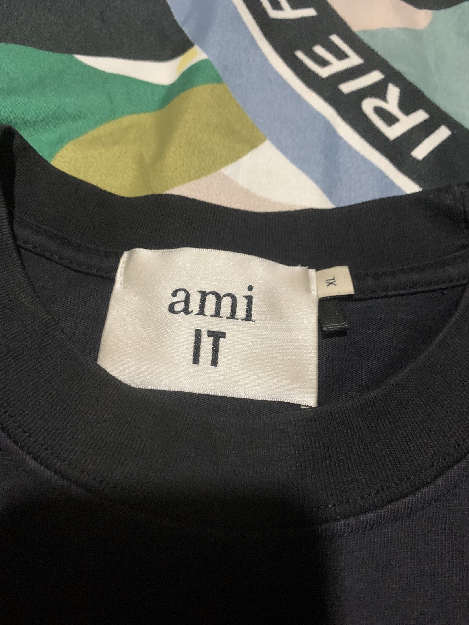 AMI Paris Black T-shirt XL (Category: Luxury Apparel) located in Cagayan de Oro. Submitted by agboysalis60090 (Listing ID 1420139585, Image 2). Description: Black AMI Paris T-shirt. Features the AMI de Coeur logo on the chest. The size is XL. The tag is visible..