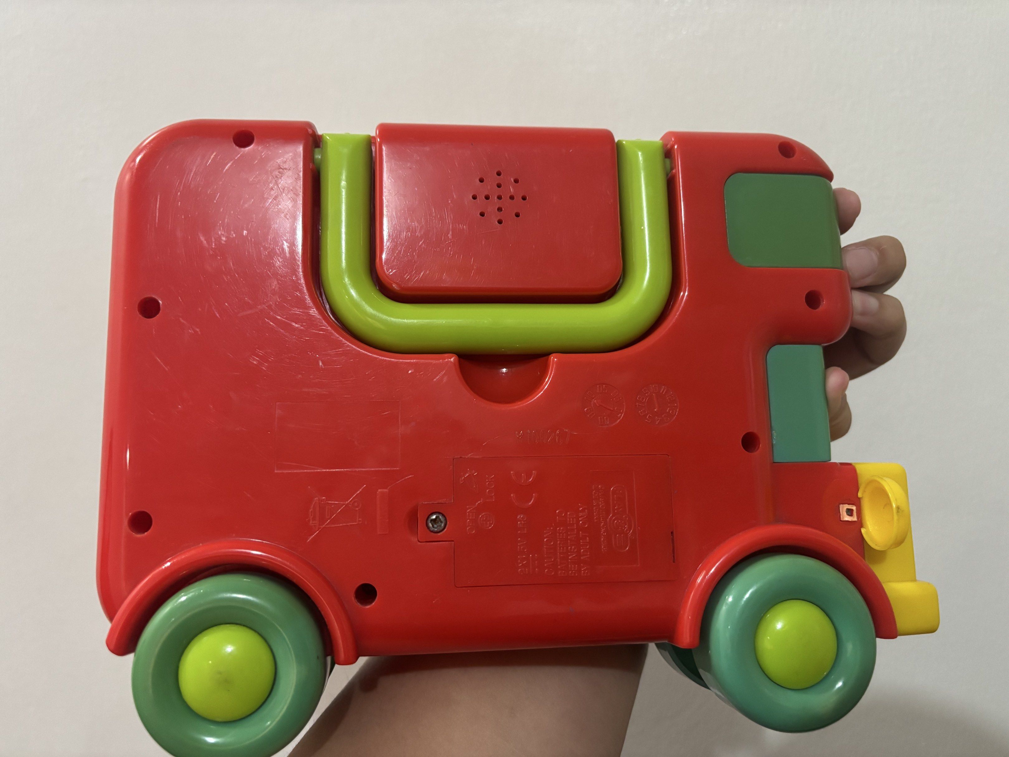 Animal Sound Bus Toy (Category: Educational & Learning Toys) located in Quezon City. Submitted by ulan-declutter (Listing ID 1420059171, Image 3). Description: - Red Animal Sound Bus toy - Plays animal sounds and numbers 1-7 - Features buttons for animal sounds and numbers - Has a green handle and green/yellow wheels - Requires batteries - One of the headlights got broken but all buttons are still functioning.