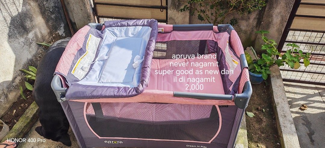 Apruva Dream 'N Play Playard (Category: Cots & Cribs) located in Manila. Submitted by puremoon_99c9e1 (Listing ID 1420087880, Image 1). Description: - Apruva Dream 'N Play crib - Features: - Changing station - Play area - Mesh sides for visibility - Wheels for easy movement - Side pocket for storage - Color scheme: Purple and pink - nasa 6k original price nya - with minimal issue na natastas lang un nasa picture pagka tastas inayawan na agad kaya