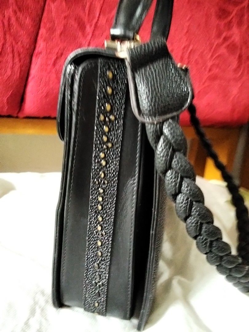 Black Stingray Leather Handbag with Braided Strap (Category: Luxury Bags & Wallets) located in Davao. Submitted by honeymeee (Listing ID 1420050486, Image 3). Description: Preloved Stingray Bag Intact Stingray material Genuine leather other part of bag, Slight Gold hardware, Replaced Strap already,One small inside zipper pocket got stuck with the inner leather, but still have bigger zipper pocket to use. .