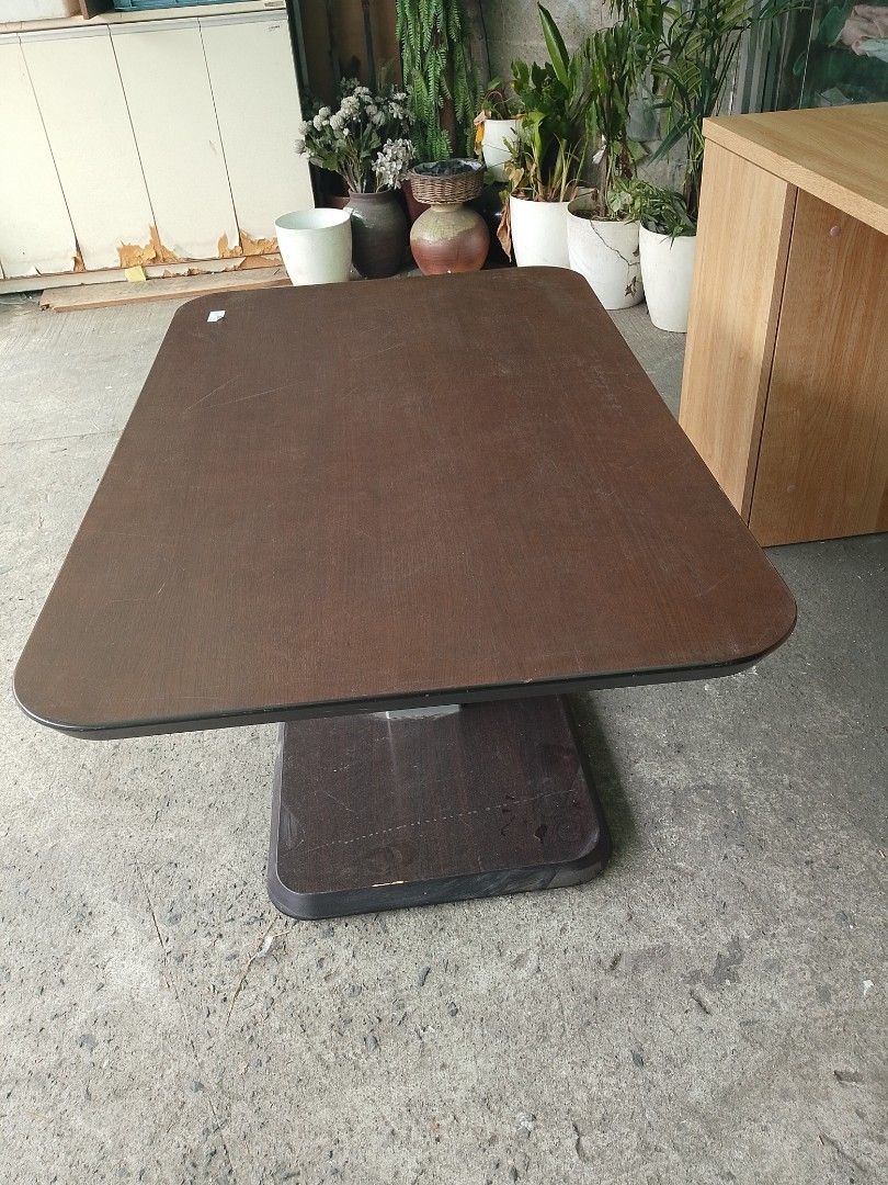 Brown Coffee Table (Category: Tables & Sets) located in Manila. Submitted by tonisfurnitureshop (Listing ID 1420005403, Image 1). Description: - Wooden coffee table - Brown tabletop - Unique pedestal base - Rectangular shape with rounded corners - Sturdy construction - Ideal for living room use - Complements various interior styles.