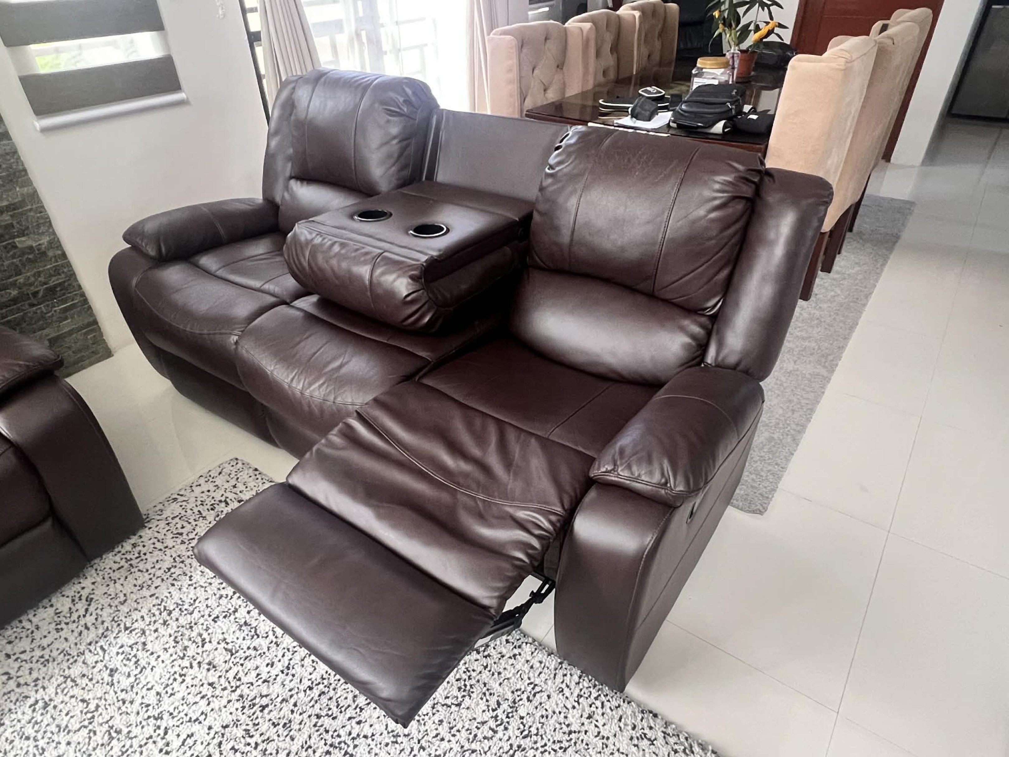 Brown Leather Reclining Sofa (Category: Sofas) located in Dasmarinas. Submitted by atasha.gsd (Listing ID 1419998525, Image 2). Description: Sigma Signature 3 Seater Recliner Size:L76xW187xH66 cm - Brown leather sofa - Reclining function - 3-seater - Built-in cup holder - Well-maintained - Comfortable and padded design - Perfect for living room RFS: We will just buy 2Seater Recliner. .