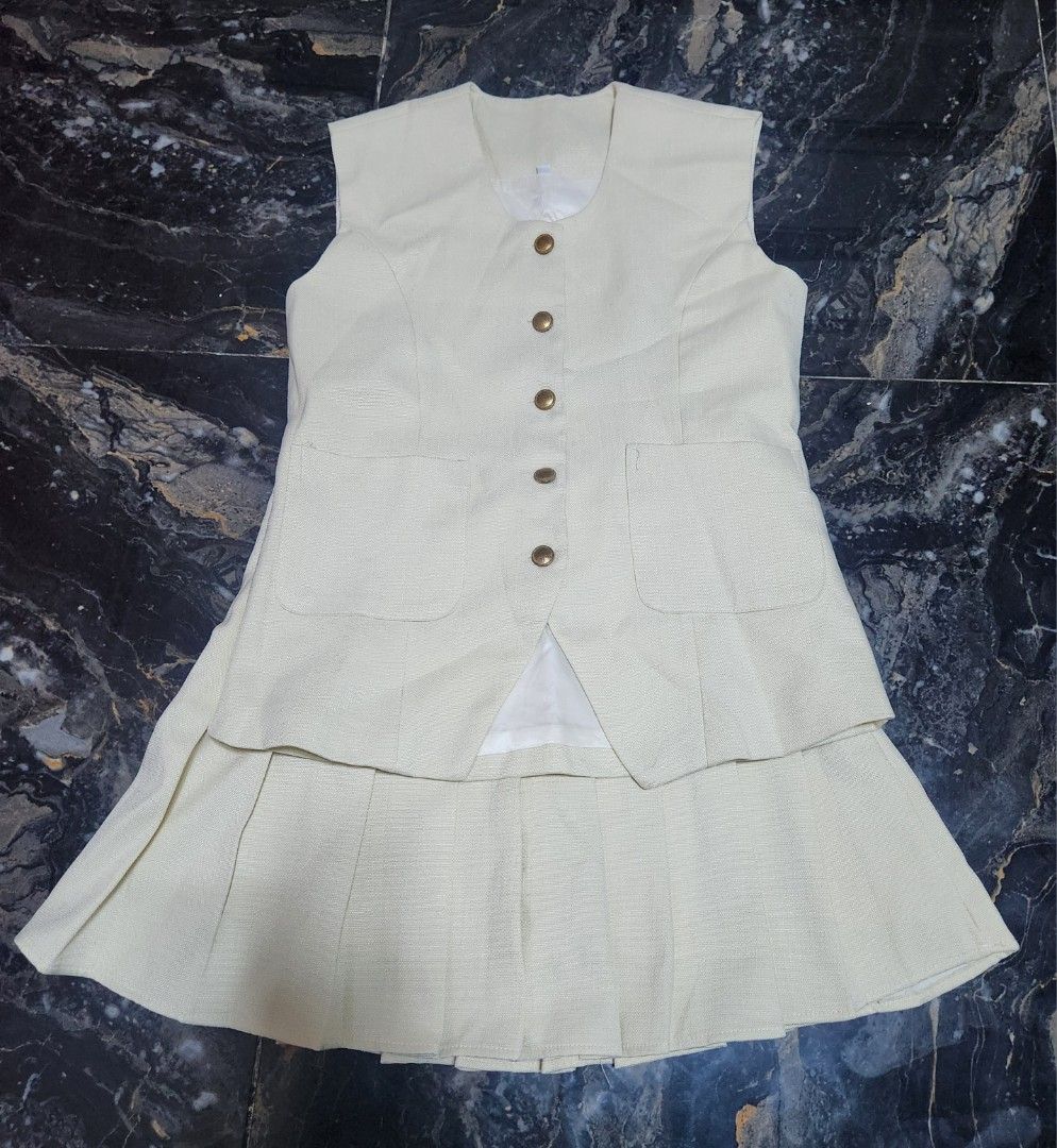 Carine Suit Pleated Skirt Set (Category: Sets or Coordinates) located in Santo Tomas. Submitted by anneiyayey (Listing ID 1420128314, Image 3). Description: - Stylish skirt set - Sleeveless vest with button closures and pockets - Pleated skirt - Beige Color - Perfect for a chic and sophisticated look -Used once only -bought for 1300.