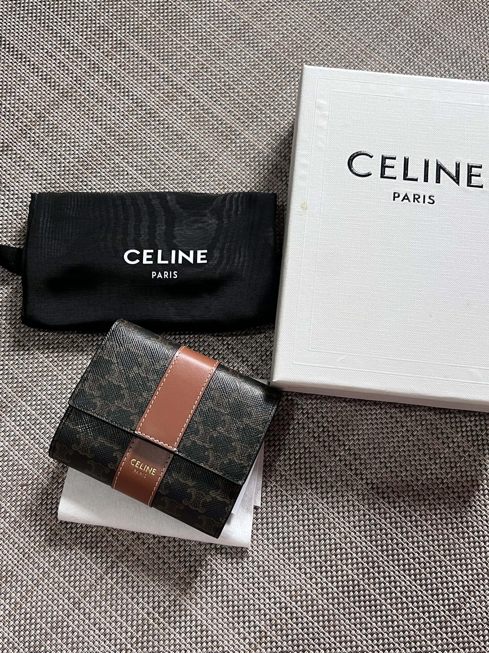 Celine Triomphe Bi-Fold Wallet (Category: Luxury Bags & Wallets) located in Manila. Submitted by luxurytreasure.ph (Listing ID 1420046595, Image 1). Description: - Celine Triomphe bi-fold wallet - Features signature Triomphe canvas - Brown leather stripe detail - Includes original box and dust bag - Made in Italy - Brown leather interior with card slots.