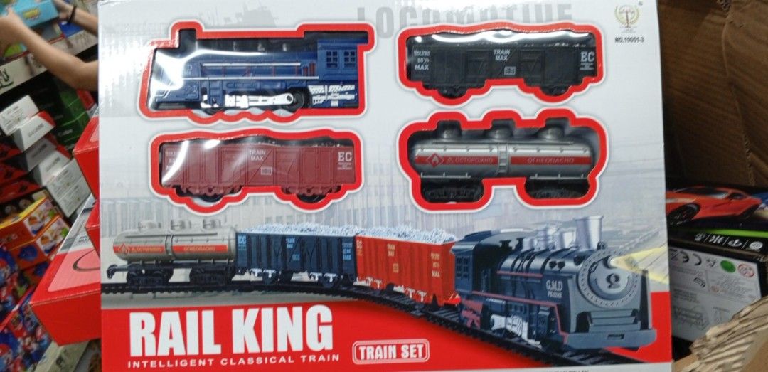 Classic Train Set with Tracks (Category: Vehicle & Diecast Models) located in Pasig City. Submitted by benildarustia18 (Listing ID 1420003370, Image 2). Description: - Rail King Train Set - Includes locomotive, carriages, and curved tracks - Working headlight - Realistic train sound - Over 190 cm orbit circumference - 11-piece set - Includes paper cards.