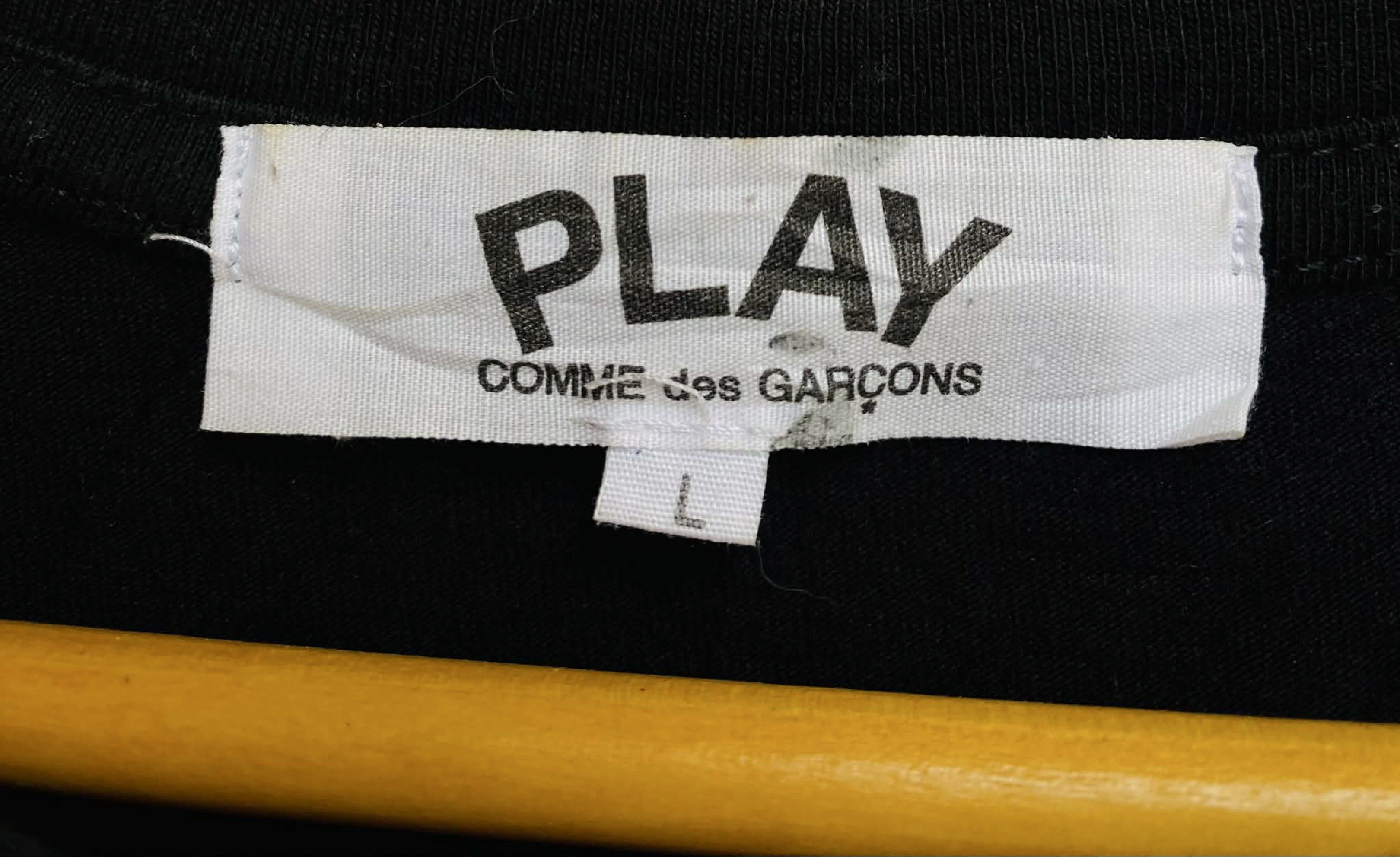 Comme des Garcons Play Black T-shirt (Category: Shirts) located in Digos. Submitted by thrifthed.ph (Listing ID 1420068499, Image 3). Description: - Comme des Garcons Play black t-shirt - Size: L -like new -dimes:21.5/28 -no issue -authentic -solid condi -solid colorate -cl:9.8/10 -need wash -complete tags -suitable for picky buyer -no return no exchange - Features the iconic red heart logo - Classic crew neck design - Short sleeves - Made from c