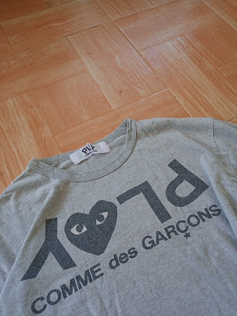 Comme des Garcons Play Grey T-shirt (Category: Tshirts & Polo Shirts ) located in Boston. Submitted by johnpaulvi30029 (Listing ID 1420013811, Image 2). Description: - Grey Comme des Garcons Play T-shirt - Features the iconic heart logo with eyes - Brand name printed on the front - Crew neck and short sleeves - Soft, comfortable fabric - Standard fit.
