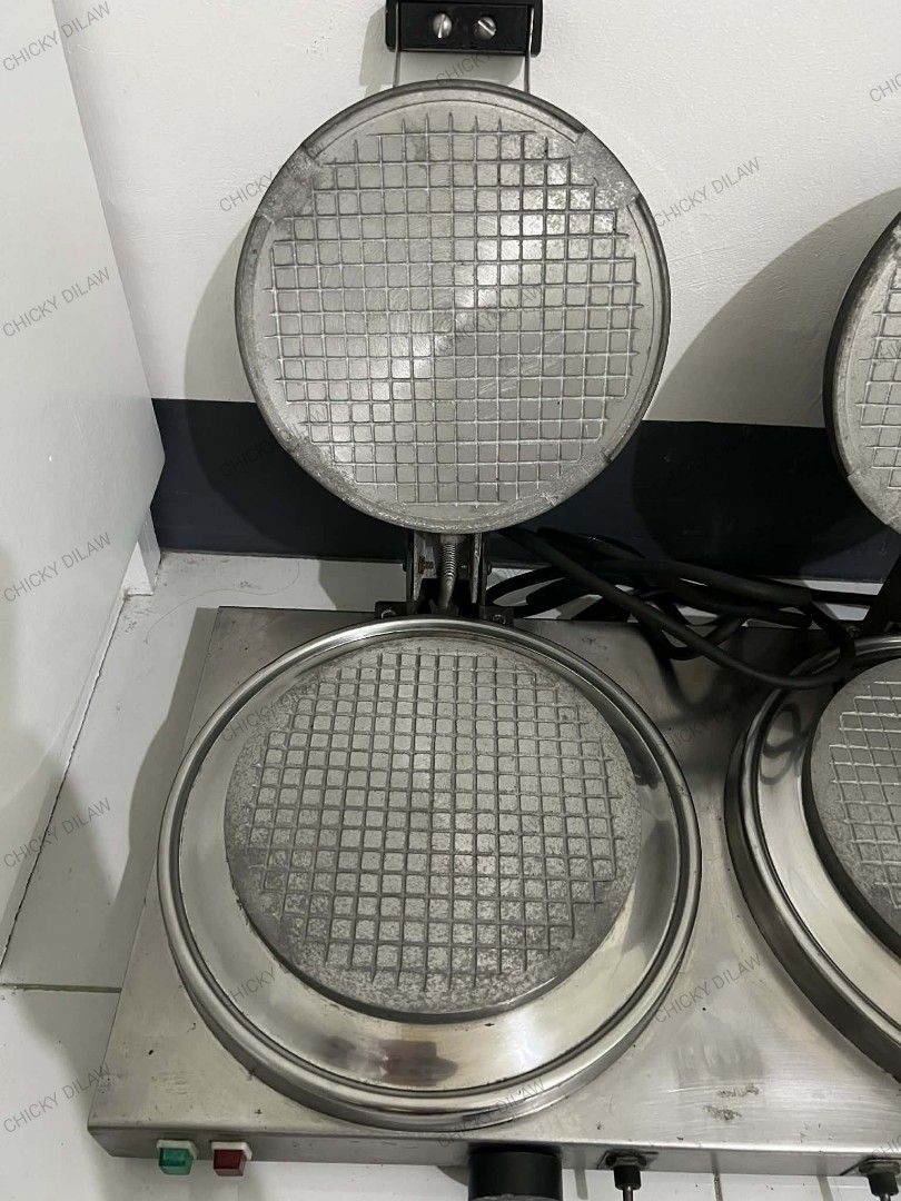 Commercial Double Waffle Maker (Category: Other Kitchen Appliances) located in Rizal. Submitted by danicahpangilinan (Listing ID 1420106689, Image 3). Description: -Commercial-grade double waffle maker. -Features two round 7-inches diameter waffle plates - Includes individual temperature controls and power indicator lights. Made of stainless steel -Includes a power cord -Perfect for commercial use like cafes or restaurants -Antipolo Location.
