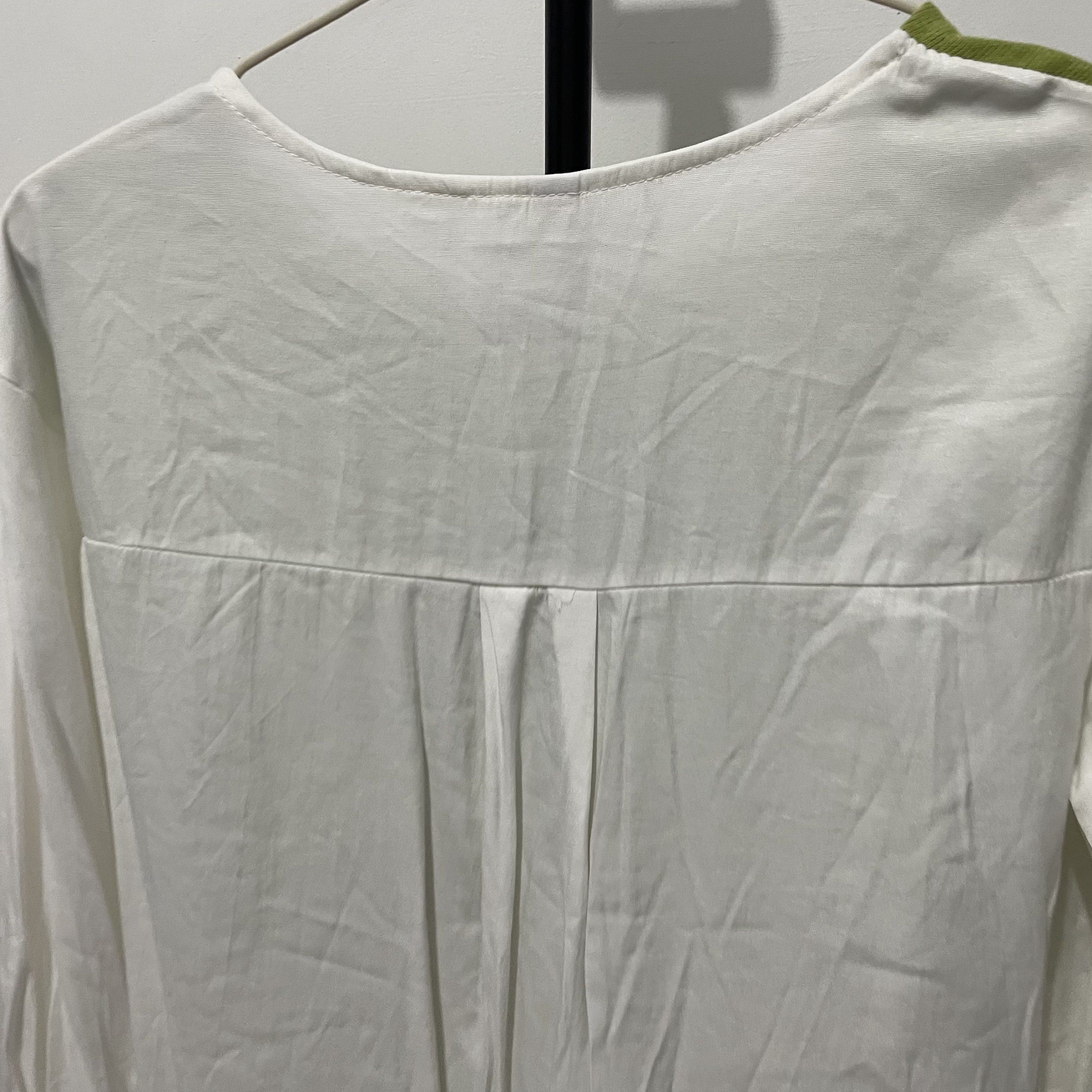 DECO Green and White Long Sleeve Top (Category: Longsleeves) located in Manila. Submitted by reloom (Listing ID 1420120090, Image 3). Description: - Brand: DECO - Small to Medium - Features a green bodice and white long sleeves. - Sleeves have gathered detail at the wrist. - Round neckline. - White back with pleat details..