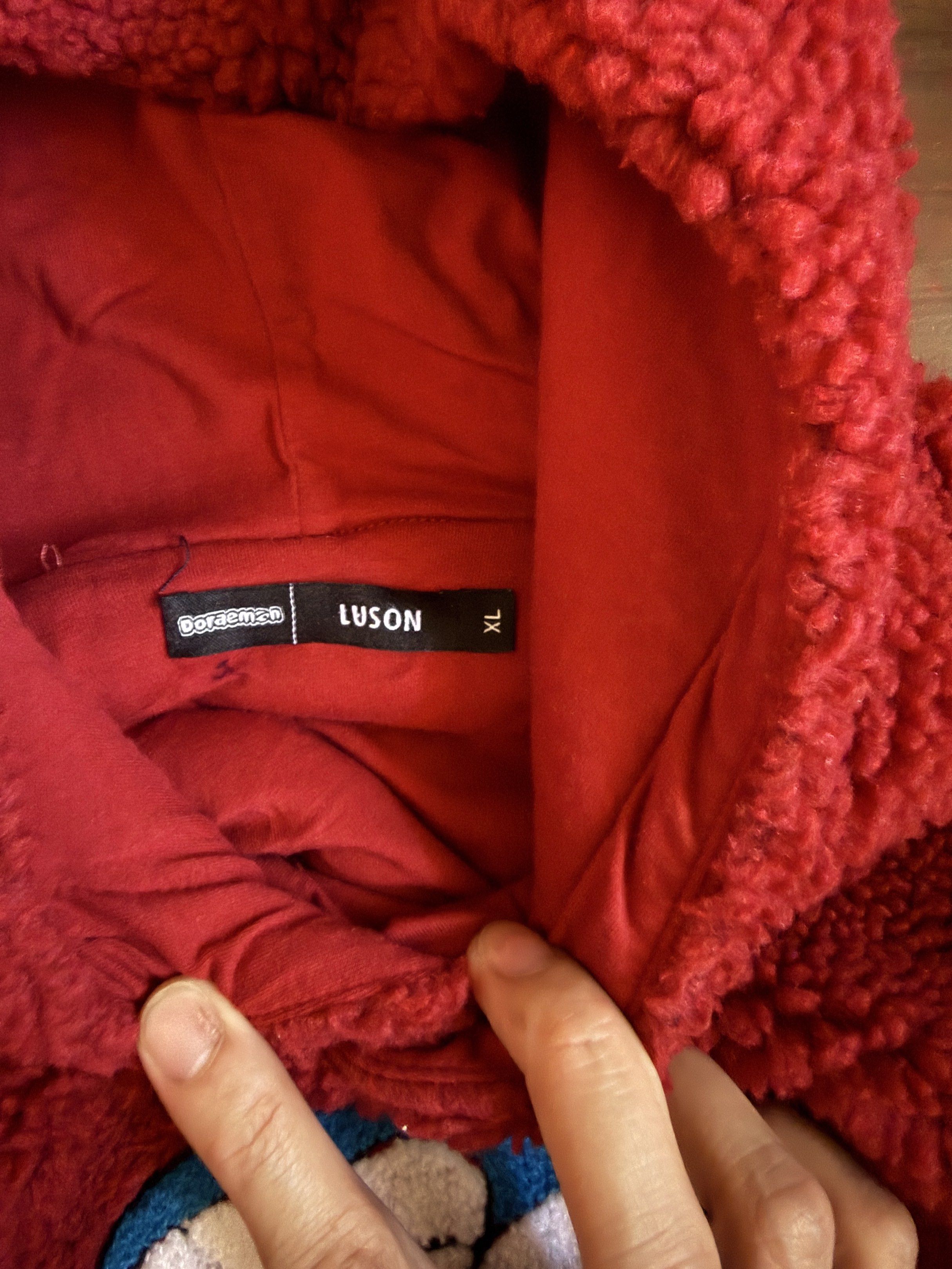 Doraemon Fleece Hoodie XL (Category: Hoodies) located in Manila. Submitted by zerachiel_ (Listing ID 1419991136, Image 2). Description: - Doraemon fleece hoodie - Deep red color - Features a large Doraemon graphic - Size: XL - Brand: Luson - With hood and ribbed cuffs/hem - Perfect for Doraemon fans.