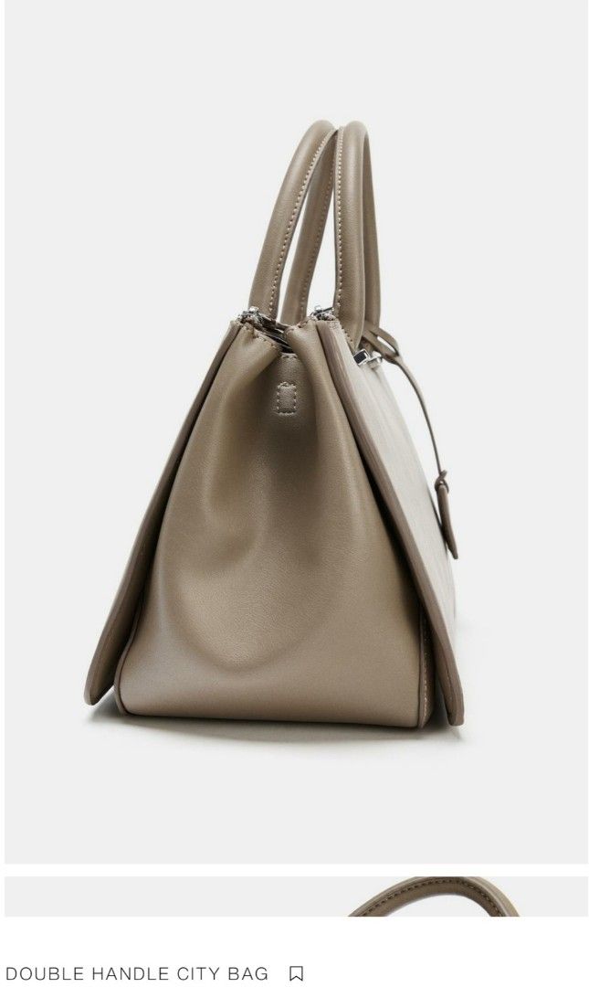 Zara Double Handle City Bag (Category: Cross-body Bags) located in Tagum. Submitted by minimelstuff (Listing ID 1420093488, Image 3). Description: - Versatile city bag - Double handle and detachable shoulder strap - Spacious interior with multiple compartments - Made of smooth material - Sleek and modern design - Includes a small tag detail - Secure zipper closure.