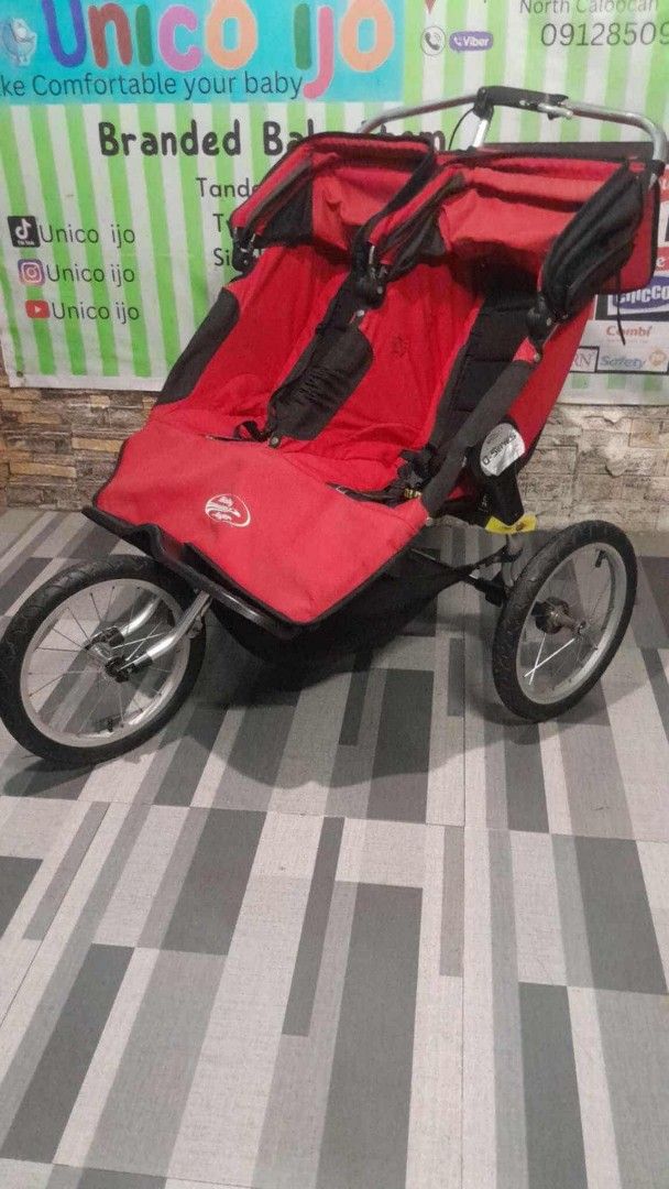 Double Stroller (Category: Strollers) located in Caloocan City. Submitted by Unicoijo02 (Listing ID 1419978282, Image 1). Description: Double stroller is perfect for parents with twins or two young children. It features a red seat and a sturdy frame. The stroller has two wheels in the front and two in the back..