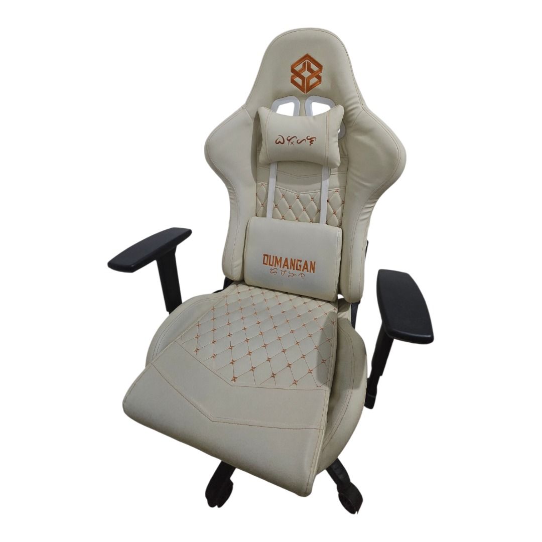 Dumangan Gaming Chair (Category: Chairs) located in Manila. Submitted by tif.decluttertime (Listing ID 1420042453, Image 1). Description: - Cream-colored gaming chair - Includes headrest and lumbar support pillow - Diamond-stitched seat and backrest - Features armrests - Five-star base with wheels - Dumangan logo on lumbar support pillow - Designed for gaming and comfort.