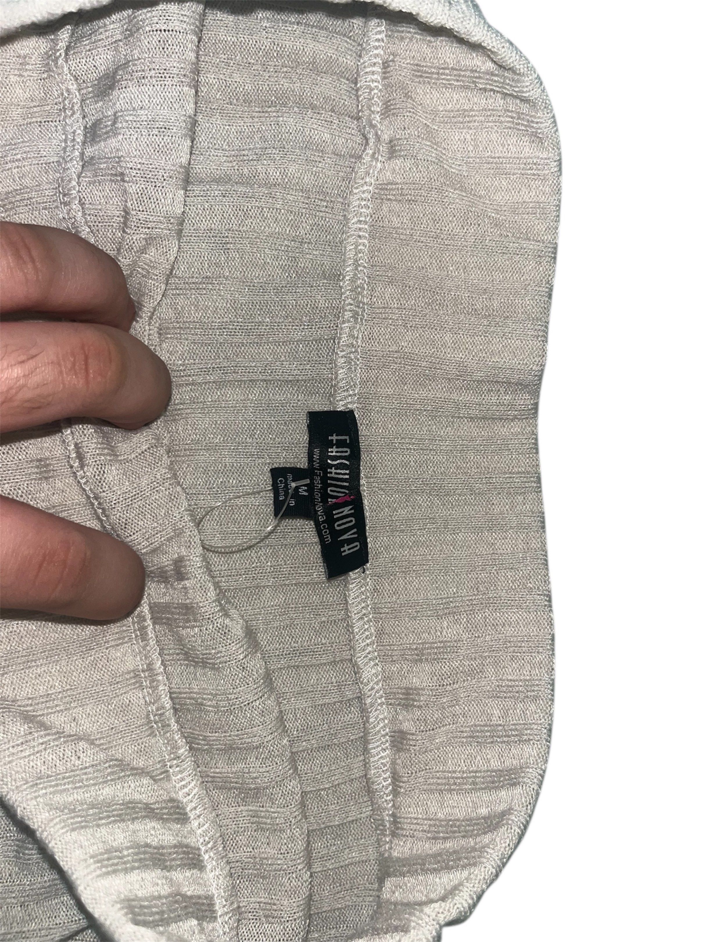 Fashion Nova Ribbed Mini Skirt (Category: Skirts) located in Agdangan. Submitted by cstlnl39 (Listing ID 1420041210, Image 2). Description: - Fashion Nova mini skirt - Size: M - Ribbed design - Neutral color - Distressed details - Knit fabric - Elastic waistband.