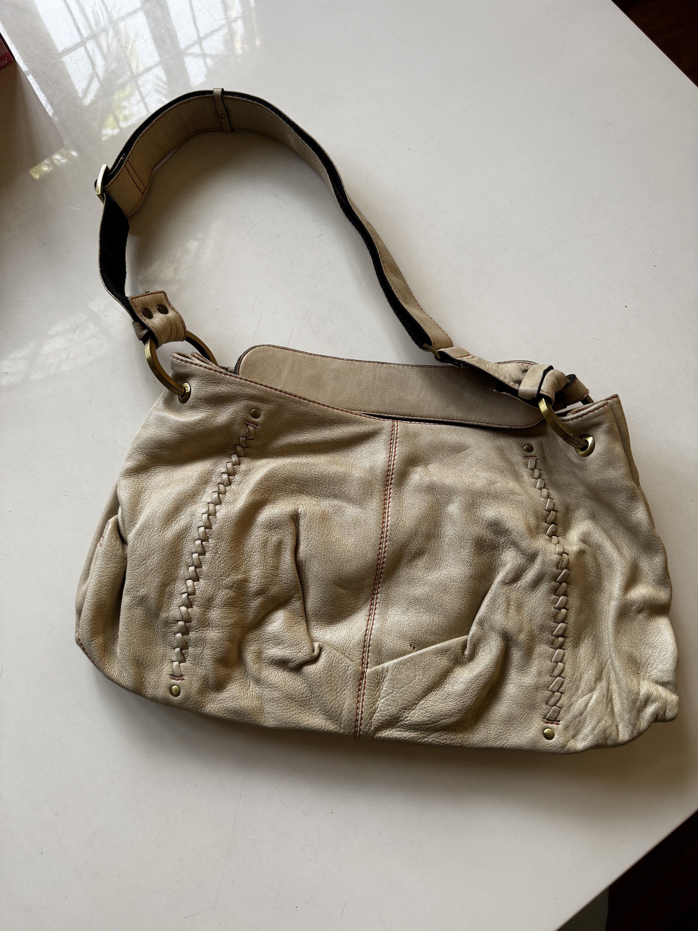 Fino Leatherware Shoulder Bag (Category: Luxury Bags & Wallets) located in Quezon City. Submitted by tulip03 (Listing ID 1420040228, Image 2). Description: - Cream-colored shoulder bag - Brand: Fino Leatherware - Design: Stitched sides with red stitch detail - Interior: Orange with zipper closure - Features: Adjustable shoulder strap - Details: Rectangular Fino Leatherware label on the front.