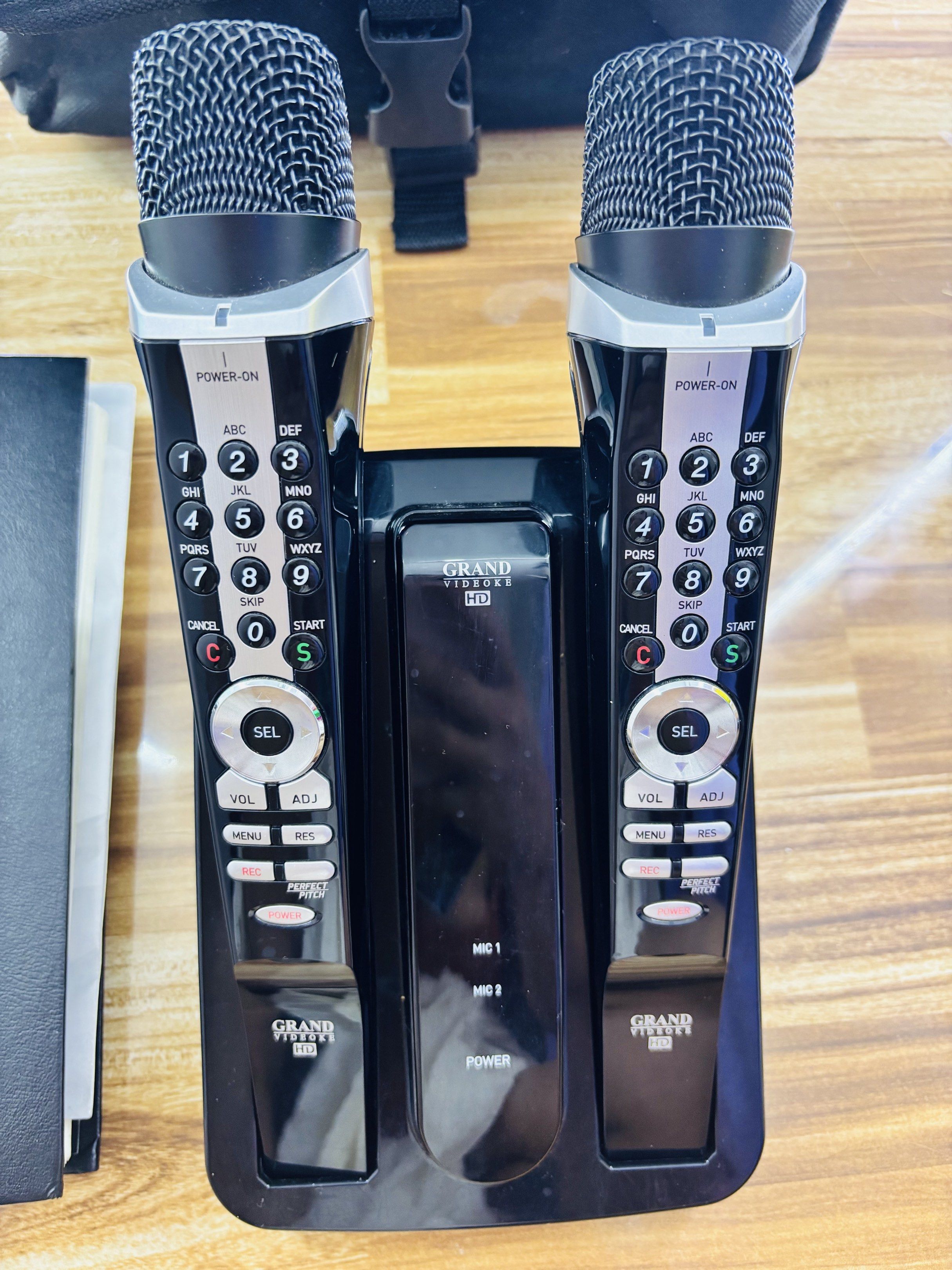 Grand Videoke HD Karaoke System (Category: Soundbars, Speakers & Amplifiers) located in Manila. Submitted by oddcloud-4794b2 (Listing ID 1420154924, Image 2). Description: - Grand Videoke HD karaoke system - Includes two microphones - Comes with a song list book - Two remote controls included - Features a charging dock - Includes power adapter and AV cables - Ready to use right away - Perfect for parties and gatherings.
