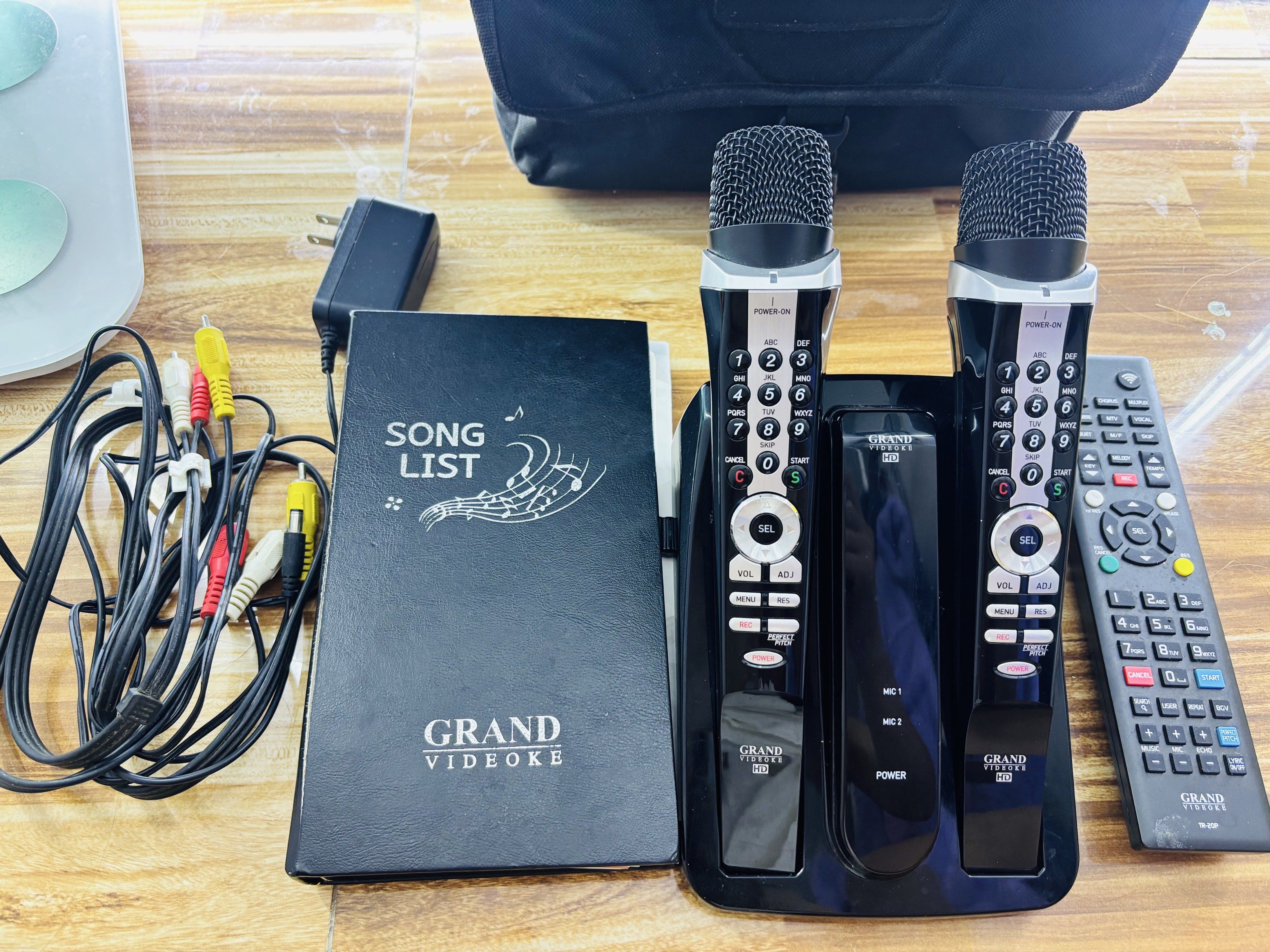 Grand Videoke HD Karaoke System (Category: Soundbars, Speakers & Amplifiers) located in Manila. Submitted by oddcloud-4794b2 (Listing ID 1420154924, Image 3). Description: - Grand Videoke HD karaoke system - Includes two microphones - Comes with a song list book - Two remote controls included - Features a charging dock - Includes power adapter and AV cables - Ready to use right away - Perfect for parties and gatherings.