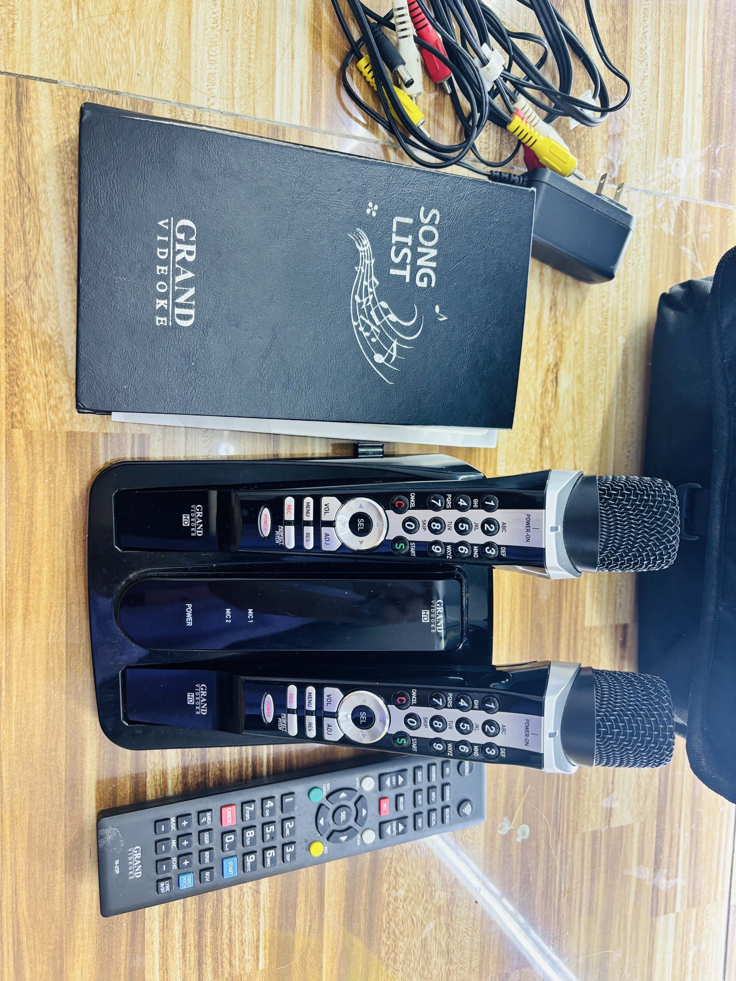 Grand Videoke HD Karaoke System (Category: Soundbars, Speakers & Amplifiers) located in Manila. Submitted by oddcloud-4794b2 (Listing ID 1420154924, Image 1). Description: - Grand Videoke HD karaoke system - Includes two microphones - Comes with a song list book - Two remote controls included - Features a charging dock - Includes power adapter and AV cables - Ready to use right away - Perfect for parties and gatherings.