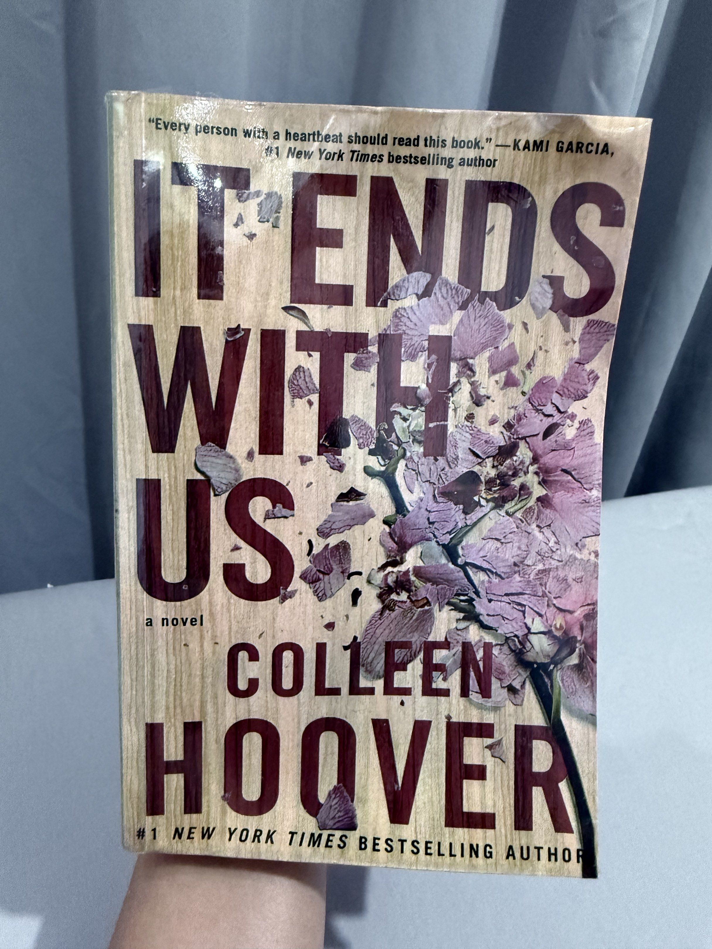It Ends With Us by Colleen Hoover (Category: Storybooks) located in Mansalay. Submitted by declutterandco (Listing ID 1420112552, Image 1). Description: - "It Ends With Us" by Colleen Hoover available. - #1 New York Times bestseller. - Features a unique wooden-like cover design. - Includes a quote from Kami Garcia. - Ideal for readers of contemporary romance..