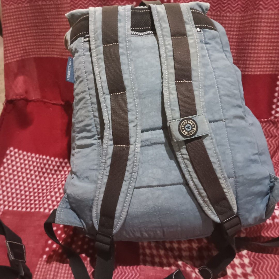 Kipling City Pack string Backpack (Category: Backpacks) located in Compostela. Submitted by andie03079 (Listing ID 1420035304, Image 2). Description: - Kipling City Pack Mini backpack - Light blue nylon exterior - Top handle - Adjustable shoulder straps Front - zippered pocket - Flap with buckle closure - Zippered main compartment - Kipling logo detail -w/ minimal flaws and it can be replaced.“side-release plastic buckle (male part)” -malaki,pang