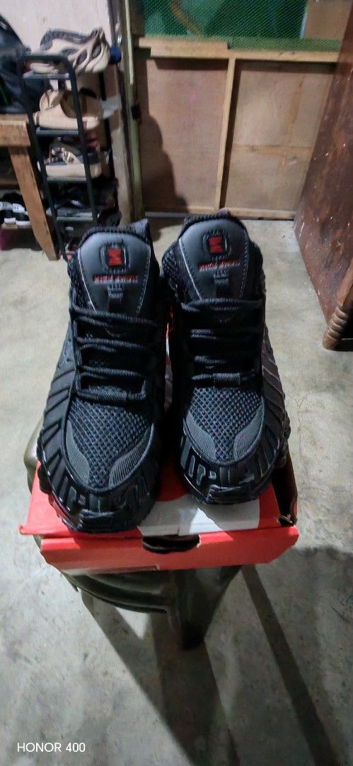 Nike Shox Black Sneakers (Category: Sneakers) located in Paranaque City. Submitted by GadgetAddicted (Listing ID 1420087882, Image 2). Description: - Black Nike Shox sneakers - Includes original red Nike box - Unique cushioned sole - Nike logo visible.