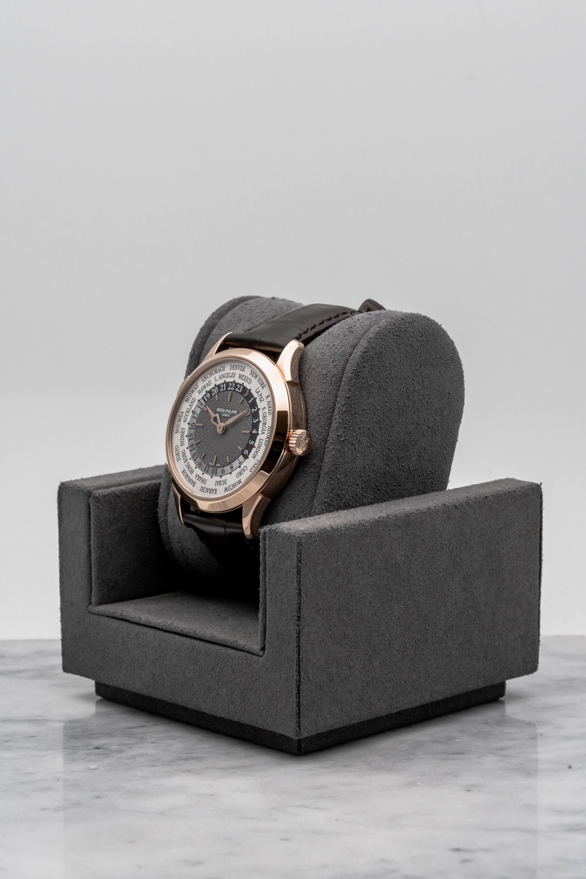 Patek Philippe World Time 5230R-001, Grey Guilloché Dial • 2019 • 📦 & 📄 (Category: Watches) located in Singapore. Submitted by timetells (Listing ID 1420023281, Image 2). Description: Brand: Patek Philippe Model: World Time Reference Number: 5230R-001 Year: 2019 Case Size: 38.5 mm Case Material: 18K Rose Gold Dial: Charcoal Gray Lacquered Dial with Guilloché Center, Gold Applied Hour Markers, City Ring and 24-Hour Ring Strap: Dark Brown Leather