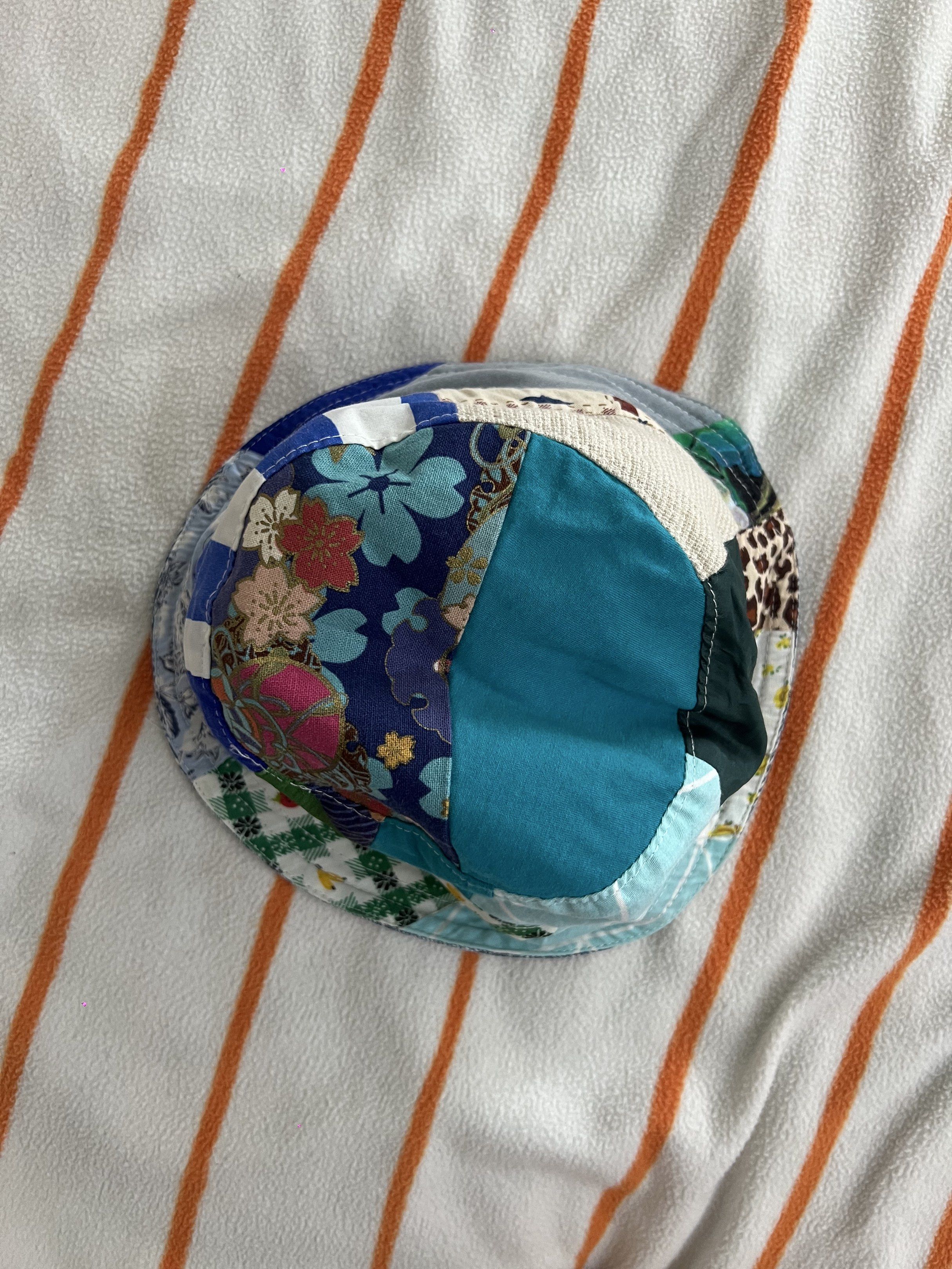 Reversible Patchwork Bucket Hat (Category: Babies & Kids Fashion) located in Singapore. Submitted by l0773 (Listing ID 1420006535, Image 3). Description: - Reversible design - One side: Denim wash - Other side: Colorful patchwork - Adds personality to your outfit - Provides sun protection - Stylish and versatile.