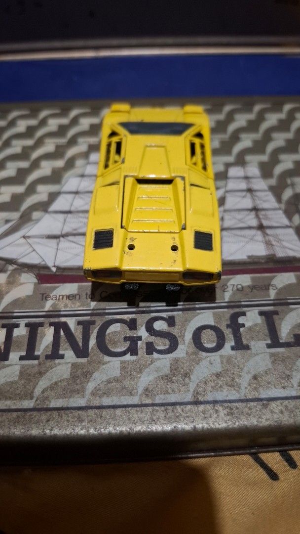 Sakura Lamborghini Countach 1/43 Super Car (Category: Vehicle & Diecast Models) located in Antipolo. Submitted by goldentiger-ac44 (Listing ID 1420042438, Image 3). Description: - Sakura Lamborghini Countach toy car - 1/43 scale - Made in Japan - Features black wheels - Detailed engine compartment - Doors can be opened - Shows some wear and tear.