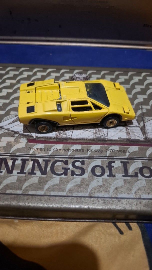 Sakura Lamborghini Countach 1/43 Super Car (Category: Vehicle & Diecast Models) located in Antipolo. Submitted by goldentiger-ac44 (Listing ID 1420042438, Image 2). Description: - Sakura Lamborghini Countach toy car - 1/43 scale - Made in Japan - Features black wheels - Detailed engine compartment - Doors can be opened - Shows some wear and tear.
