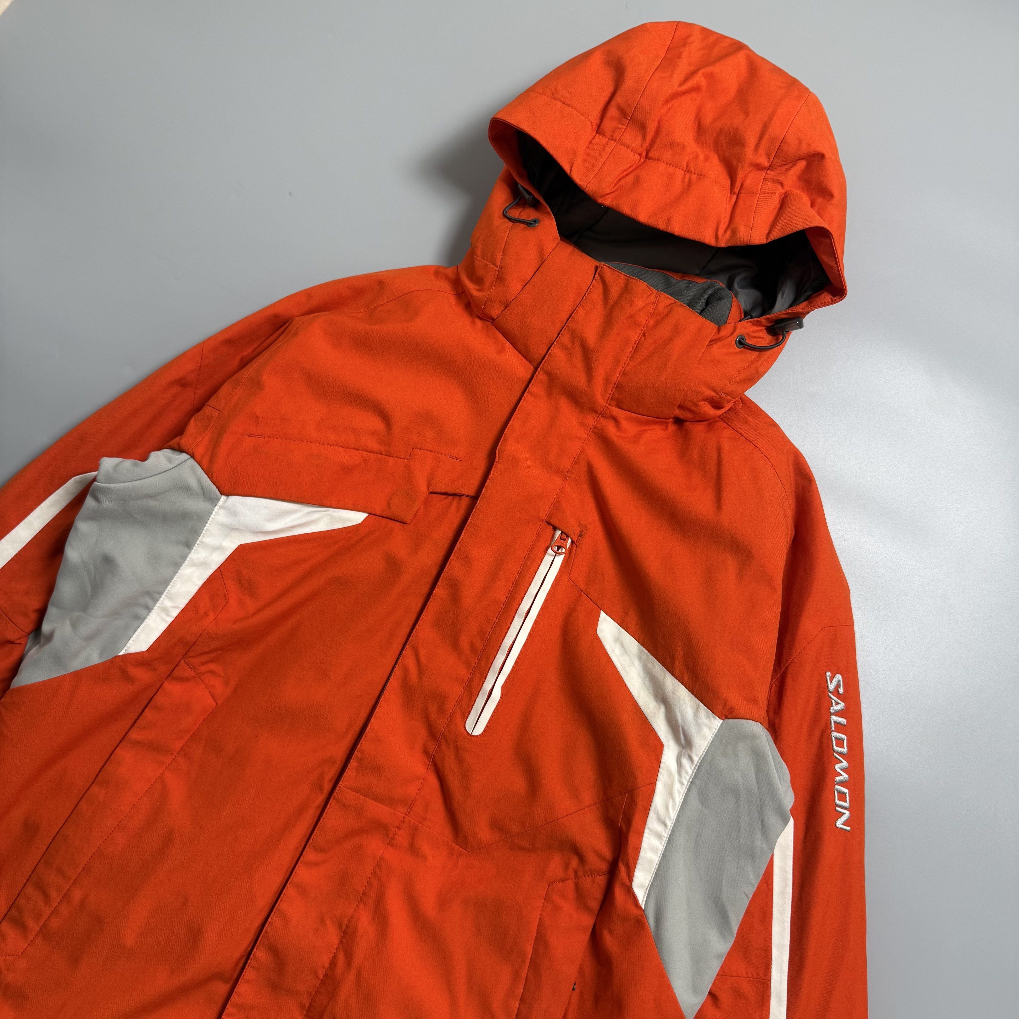 Salomon Insulated Ski Jacket w/ RECCO (Category: Coats, Jackets and Outerwear) located in Cebu City. Submitted by inukaybyjlf (Listing ID 1420114516, Image 2). Description: Authentic Salomon performance winter jacket Bright orange technical ski jacket featuring full insulation, fixed hood, powder skirt, ventilation zips, multiple functional pockets, and built-in RECCO avalanche rescue reflector. Designed for alpine skiing & snowboarding. Warm, du