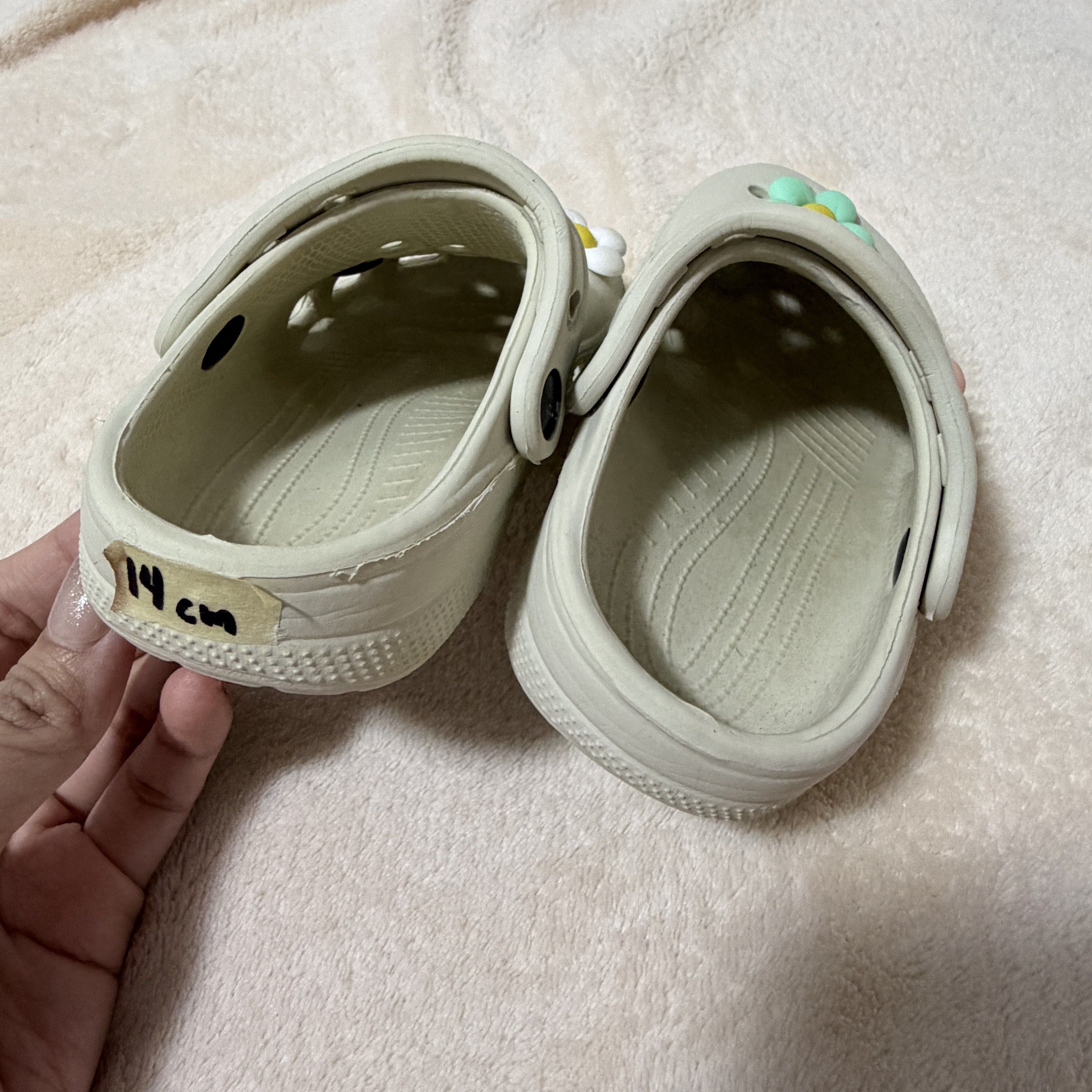 Sandals with Flower Charms (Category: Babies & Kids Fashion) located in Batangas. Submitted by chloclo.declutter (Listing ID 1420013321, Image 3). Description: - Light beige sandals - Adorned with colorful flower charms - Features a secure strap - Size: 14 cm .
